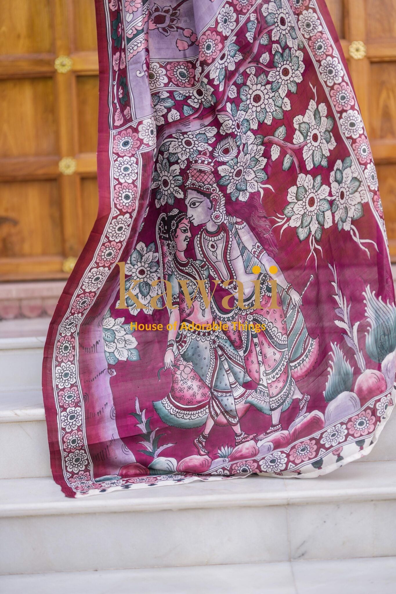 Kawaii kalamkari saree with intricate floral and traditional artwork in maroon and white colors