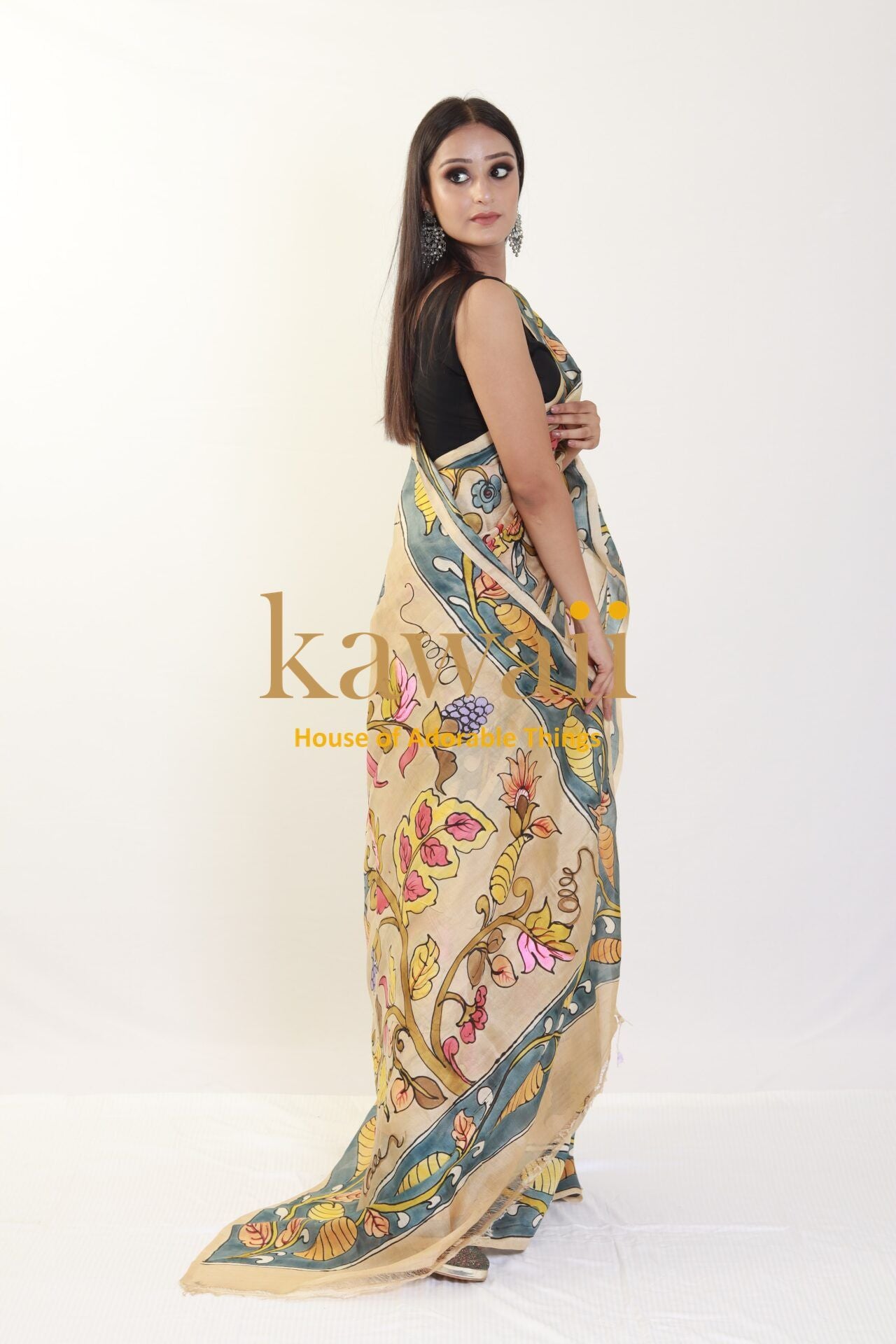 Kawaii kalamkari saree with intricate floral and paisley designs draped on a woman in a black blouse