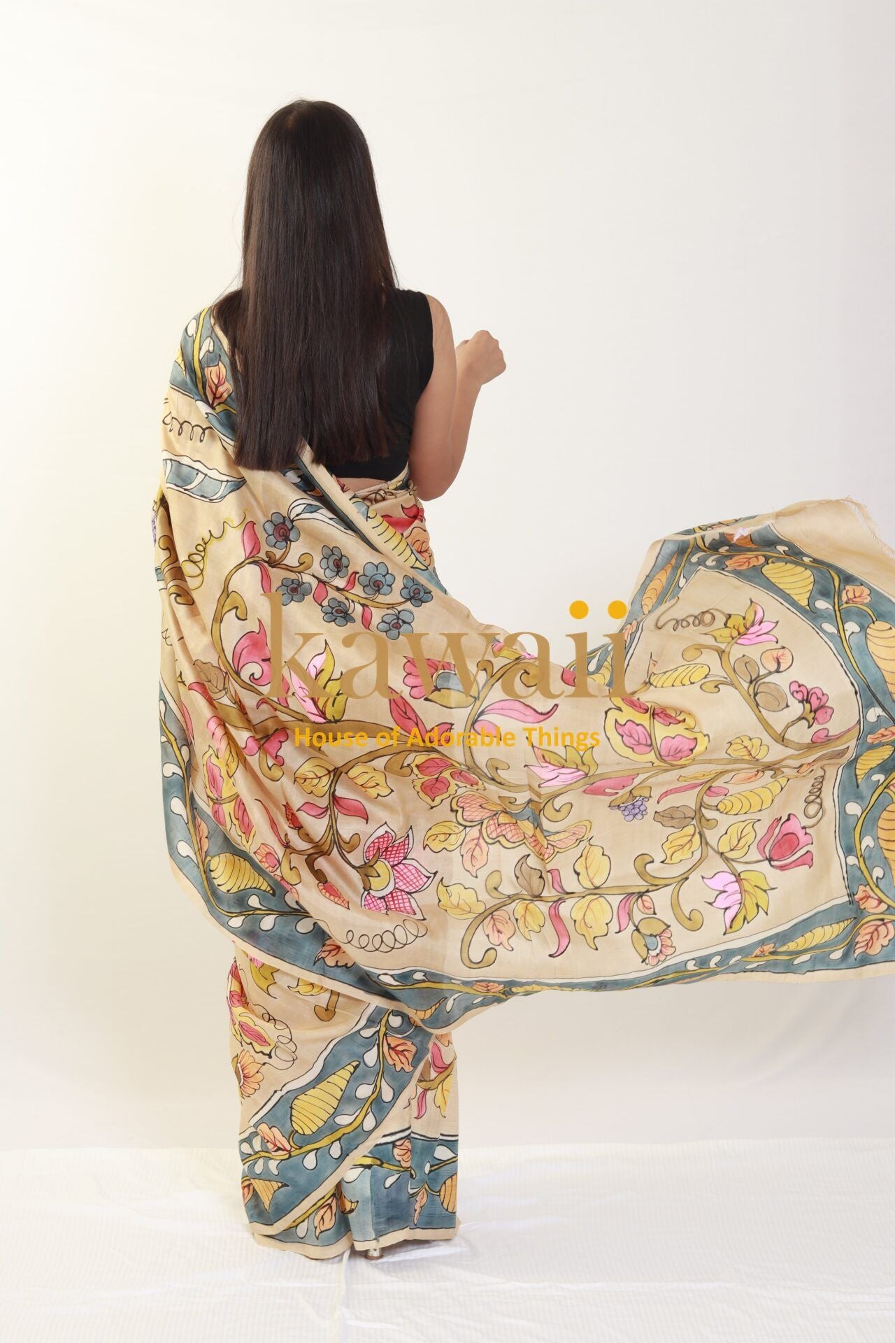 Kawaii kalamkari saree with floral and vine patterns worn by woman seen from back