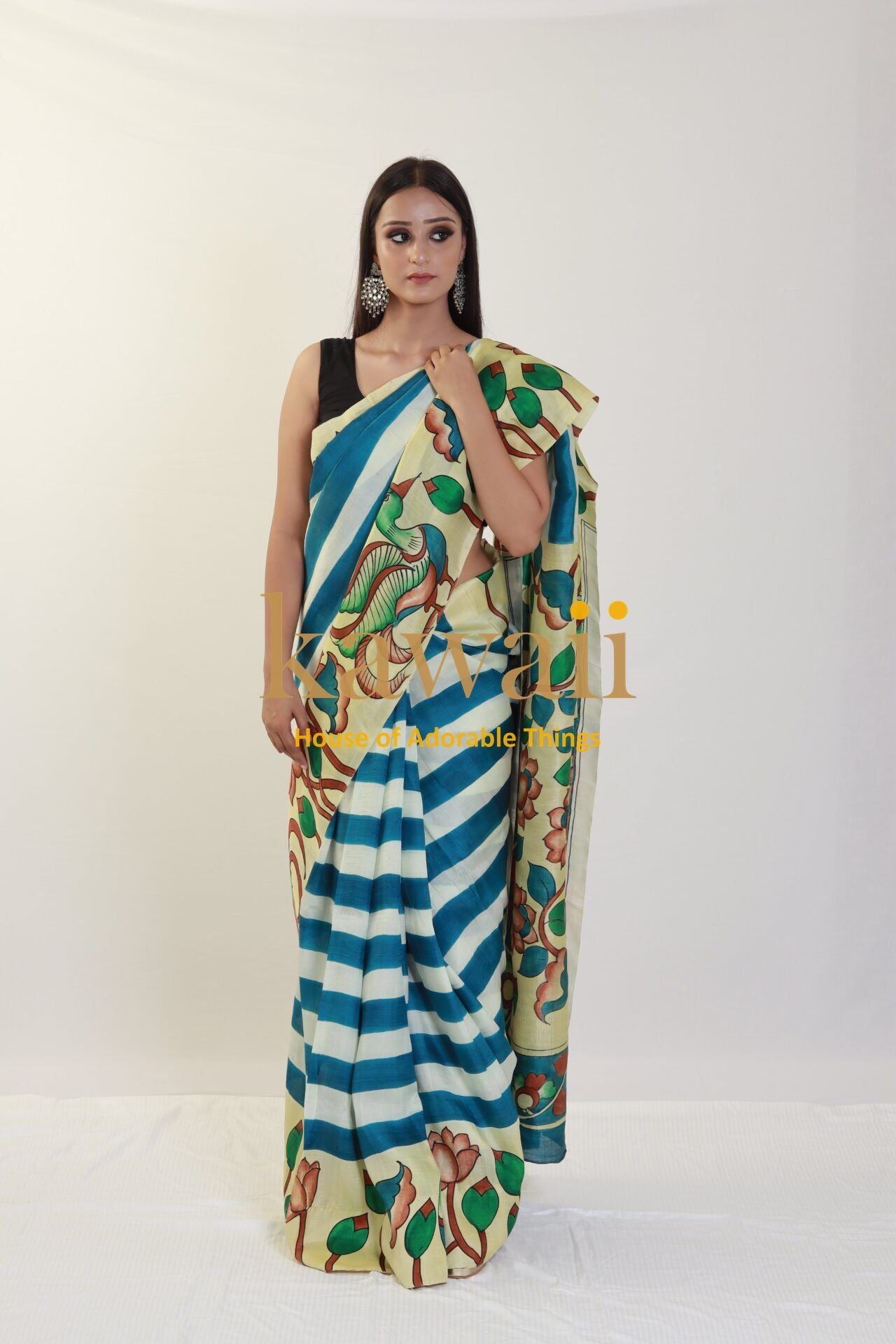 Kawaii kalamkari saree with blue and white stripes and floral patterns modeled by a woman in black blouse