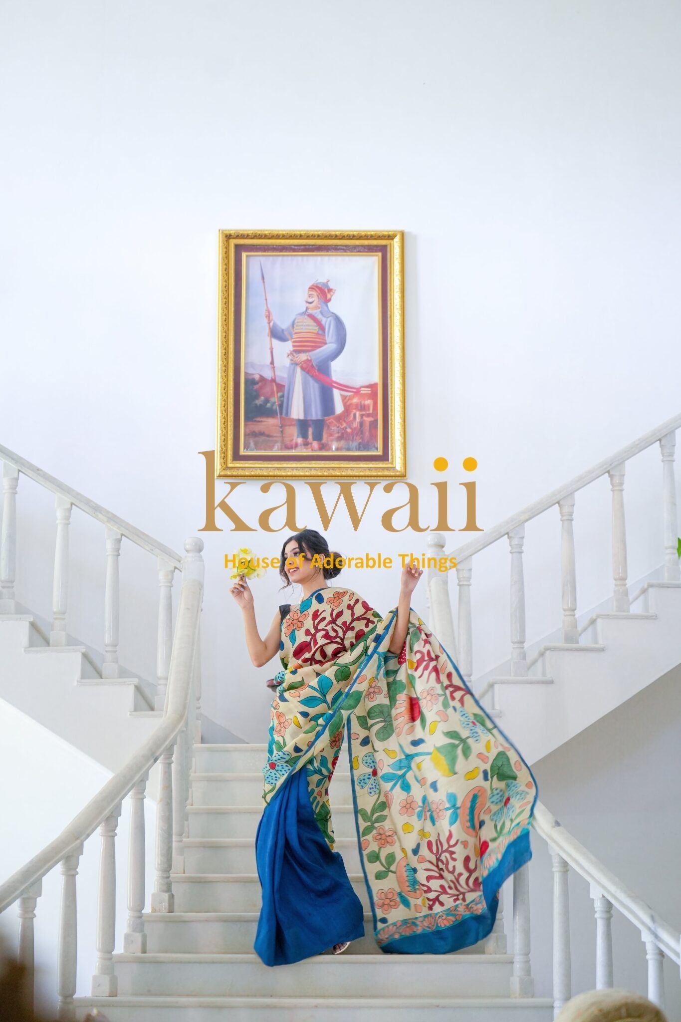 Kawaii kalamkari saree with colorful traditional patterns worn by woman on white staircase