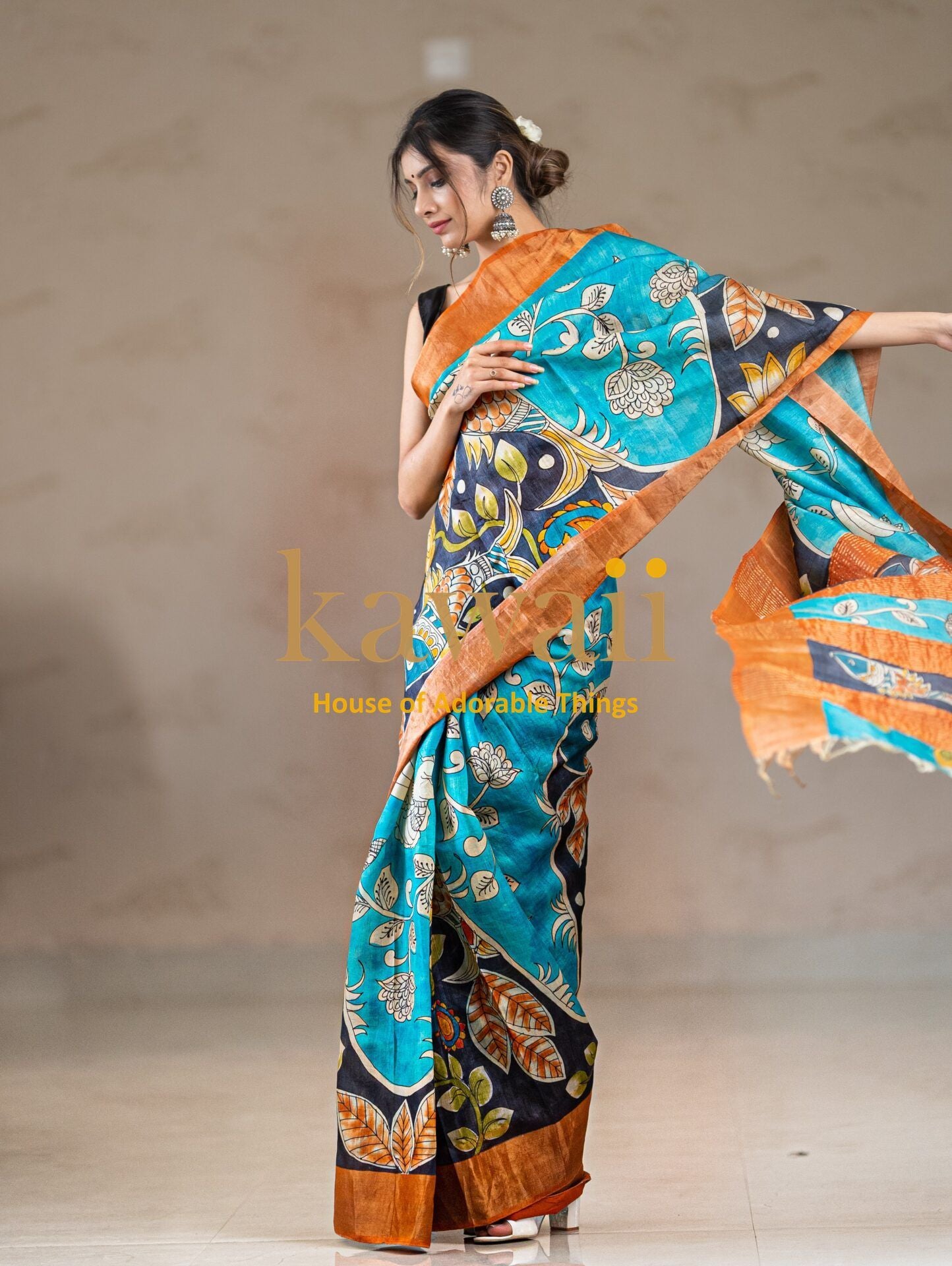 Kawaii kalamkari saree in teal and black with intricate floral patterns and mustard orange border