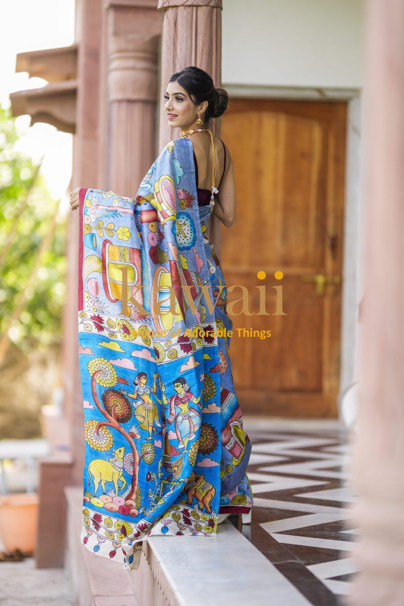 Kawaii kalamkari saree featuring vibrant traditional Indian art worn by a woman with an elegant hairstyle