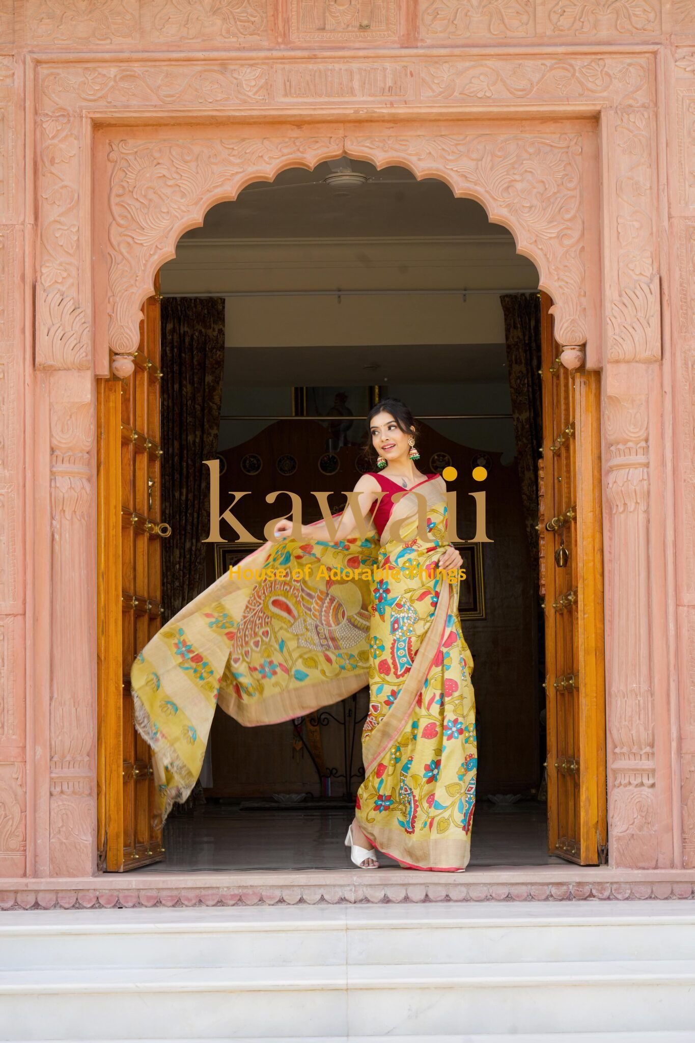 Woman wearing colorful kalamkari saree standing in traditional carved doorway by Kawaii