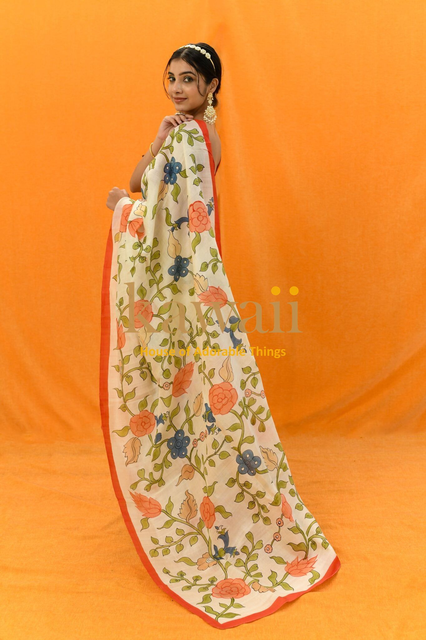 Woman wearing Kawaii kalamkari saree online with floral handcrafted sarees in India design