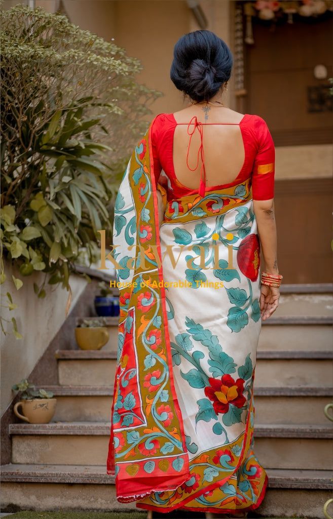 Kawaii kalamkari saree with vibrant floral patterns draped on a woman wearing a red blouse with open back design