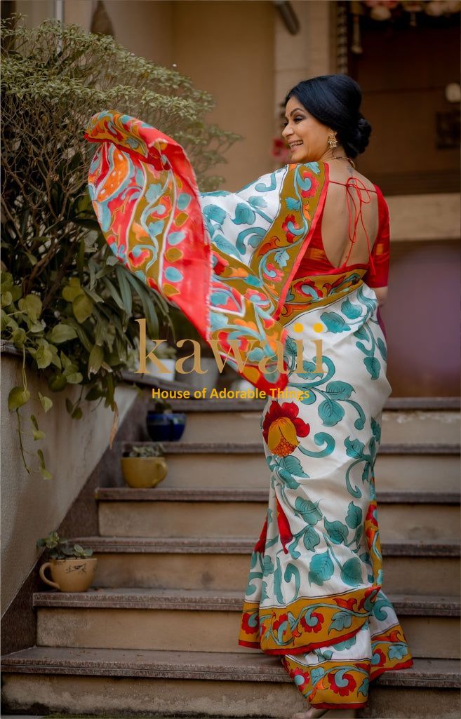 Kawaii kalamkari saree with colorful floral patterns worn by woman on stairs in elegant pose