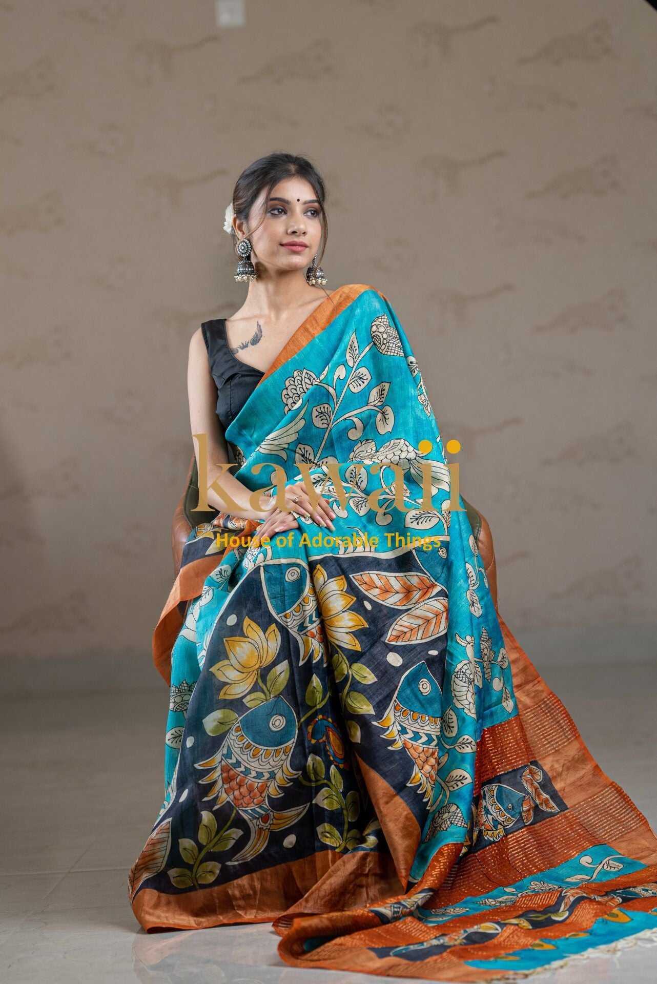 Kawaii kalamkari saree in blue with intricate floral and bird patterns worn by a model