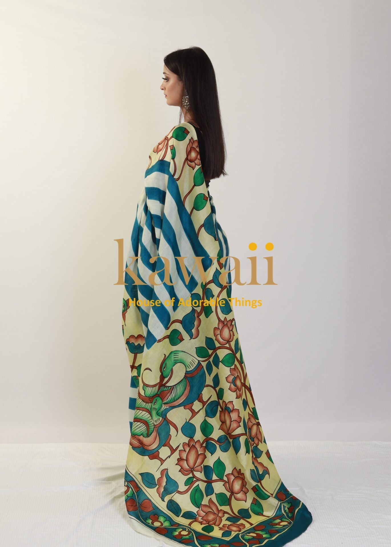 Kawaii kalamkari saree with floral and striped patterns draped on a woman standing sideways