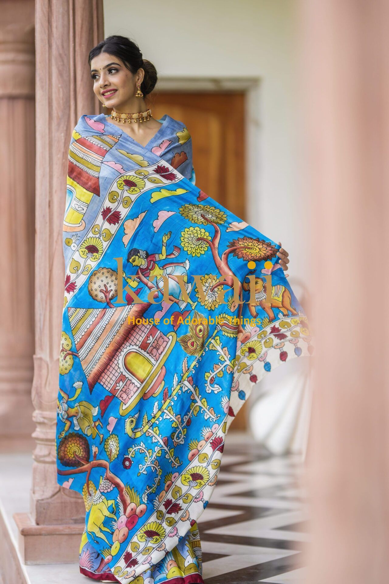 Kawaii kalamkari saree with intricate colorful traditional patterns worn by woman in elegant setting