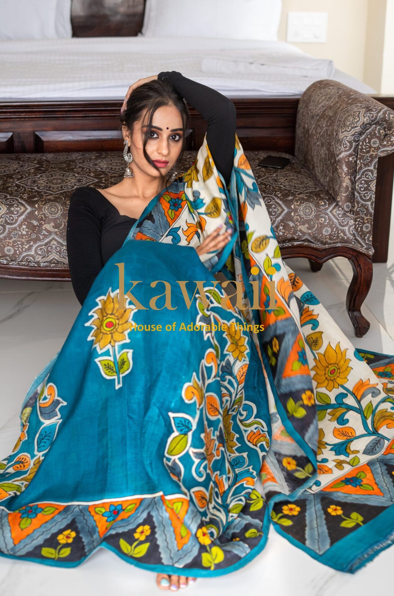 Kawaii kalamkari saree draped by model showcasing vibrant floral and geometric patterns in blue and yellow