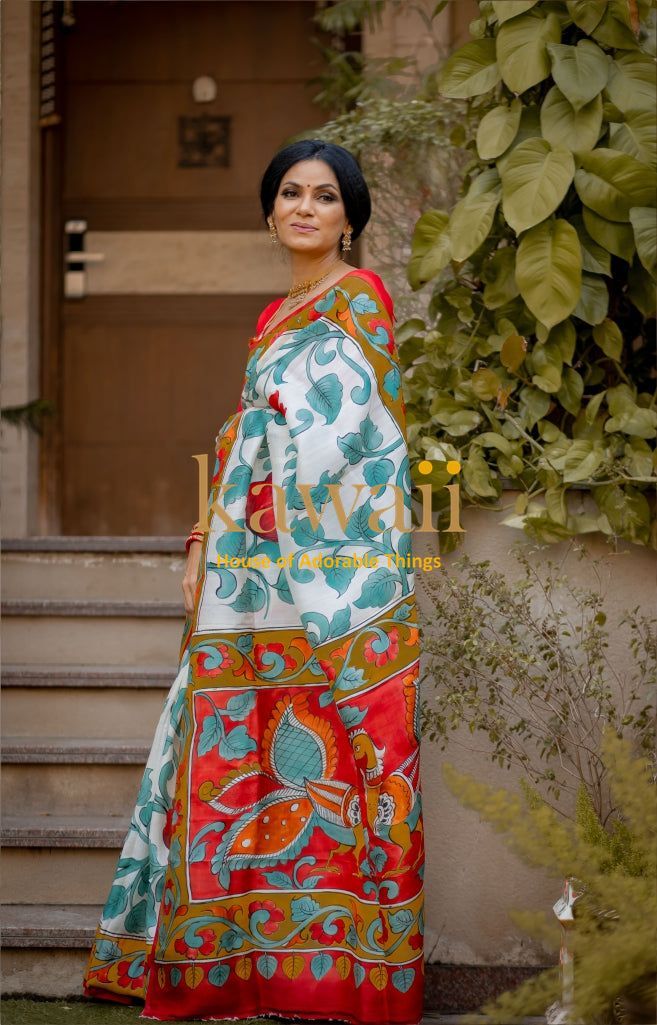 Kawaii kalamkari saree with vibrant floral and leaf patterns worn by a woman standing outdoors