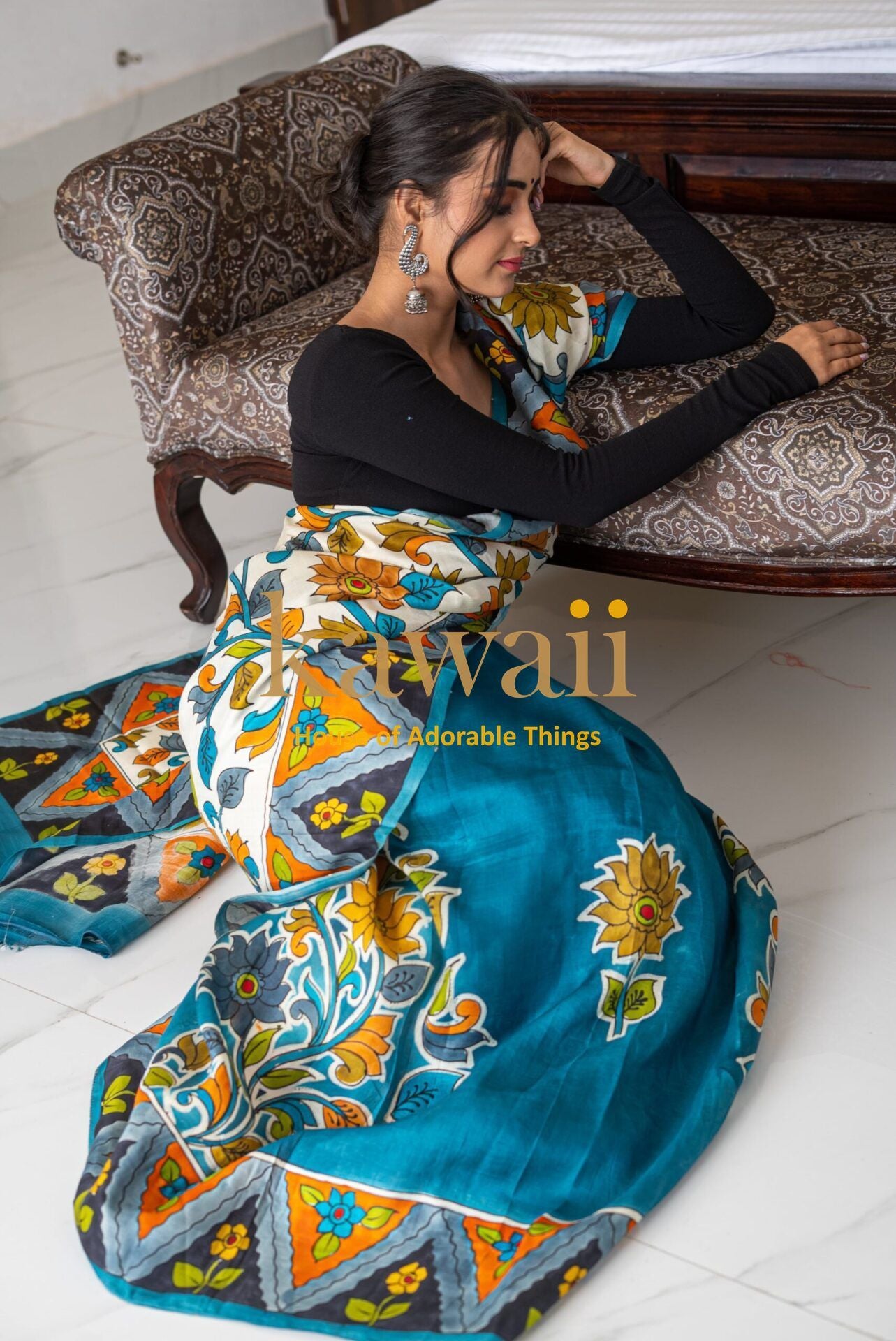 Woman wearing a vibrant blue kalamkari saree with floral and geometric patterns by Kawaii