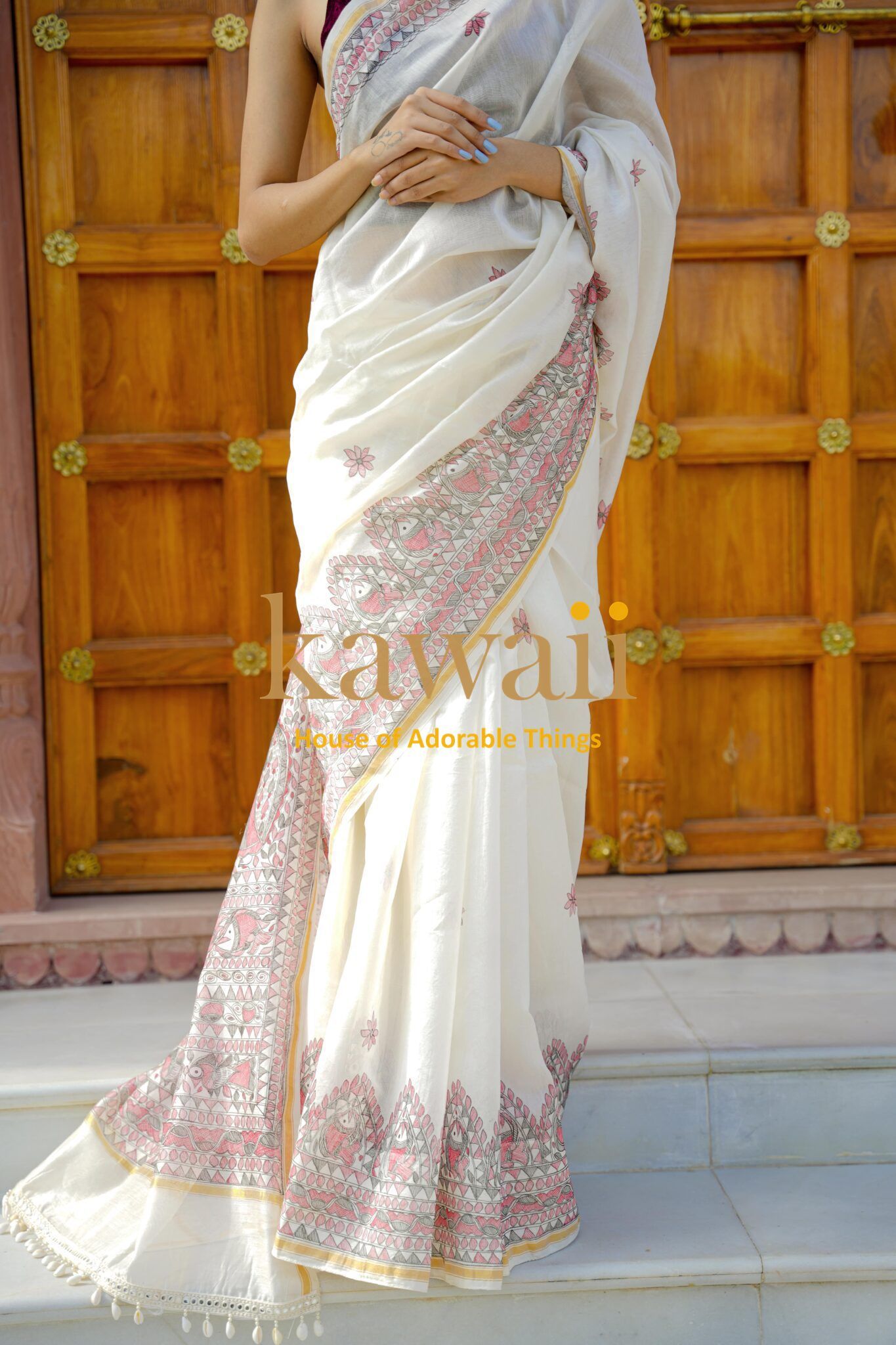 Elegant white Madhubani saree with intricate pink and gold border designs by Kawaii