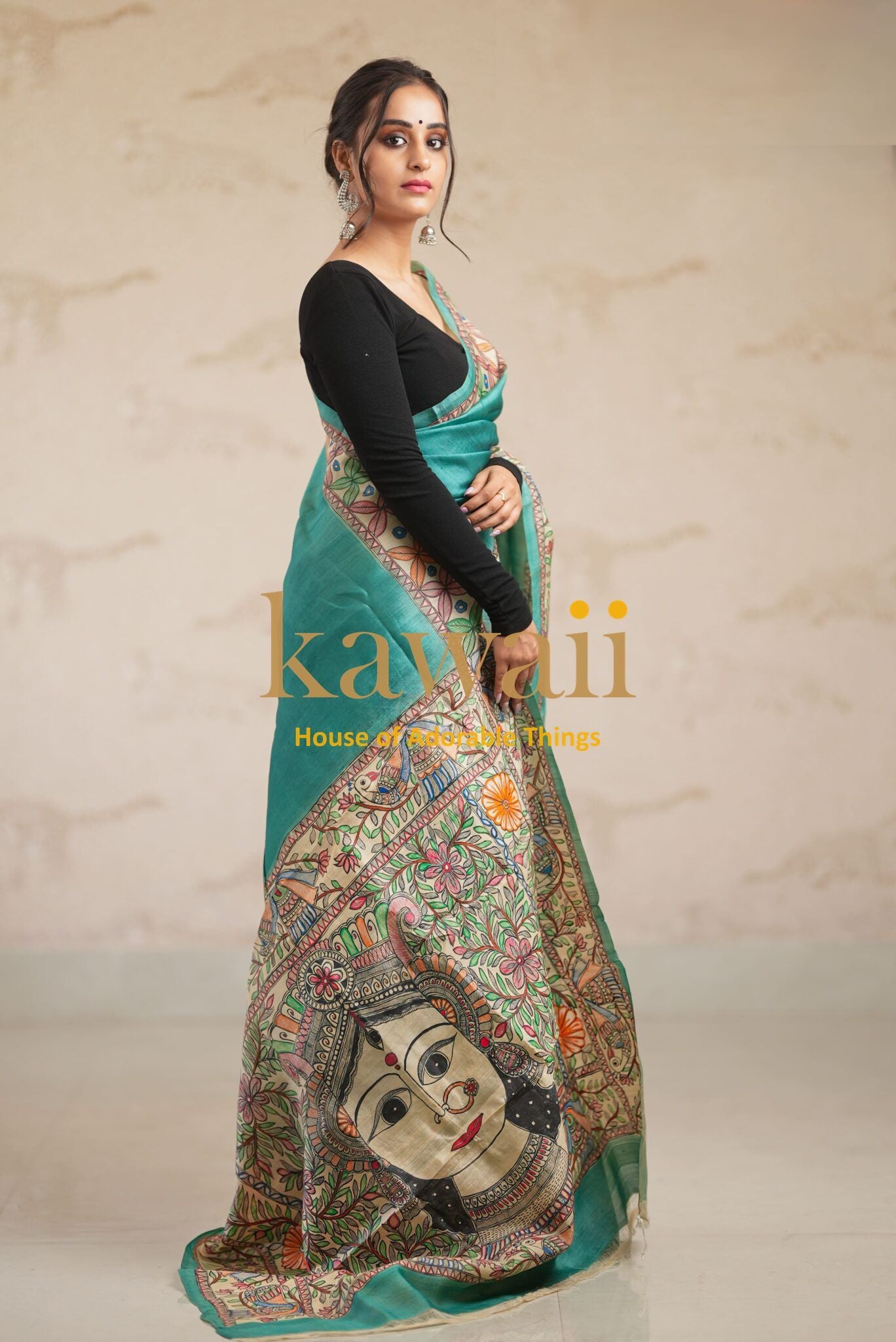 Kawaii green madhubani saree featuring traditional artwork and detailed border design