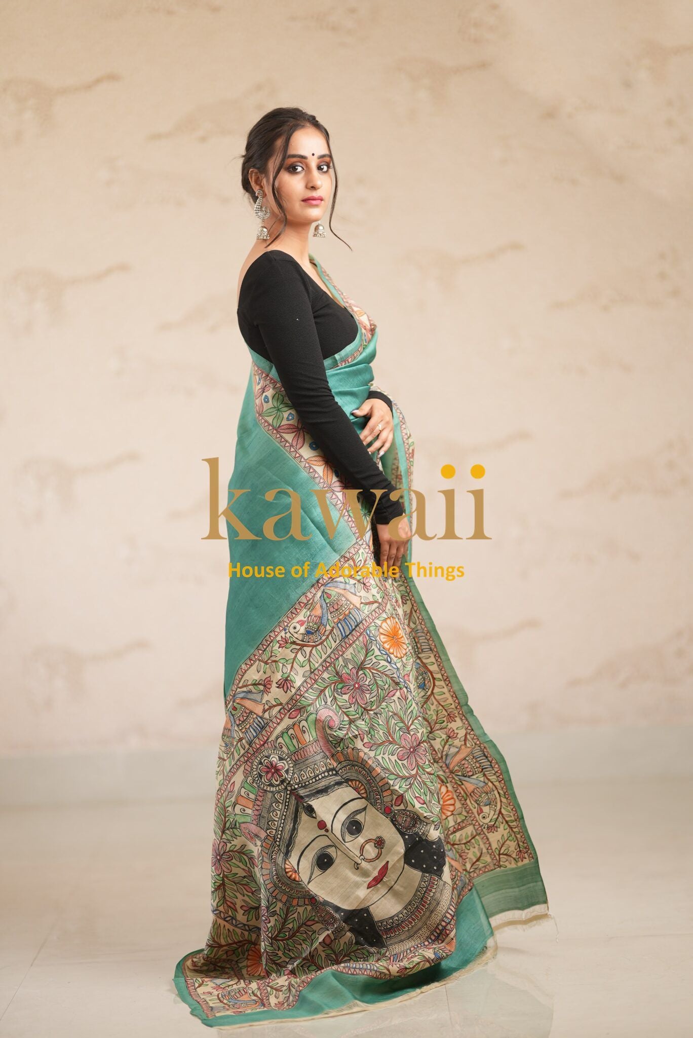 Kawaii madhubani saree in green with intricate traditional artwork and woman wearing black blouse