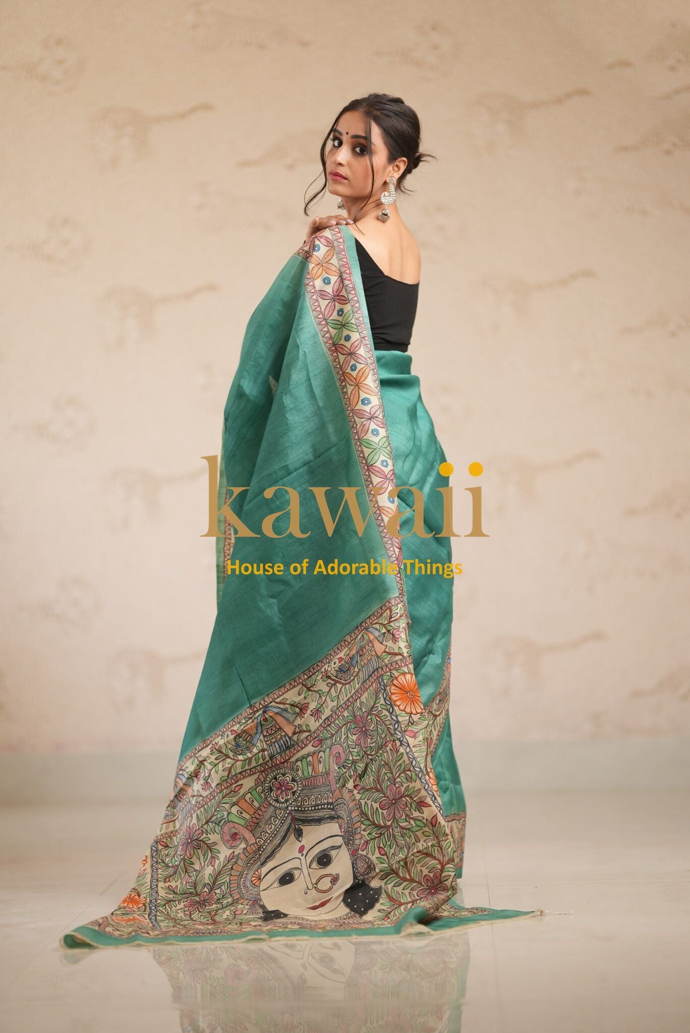 Kawaii green madhubani saree featuring traditional intricate artwork with a detailed painted border