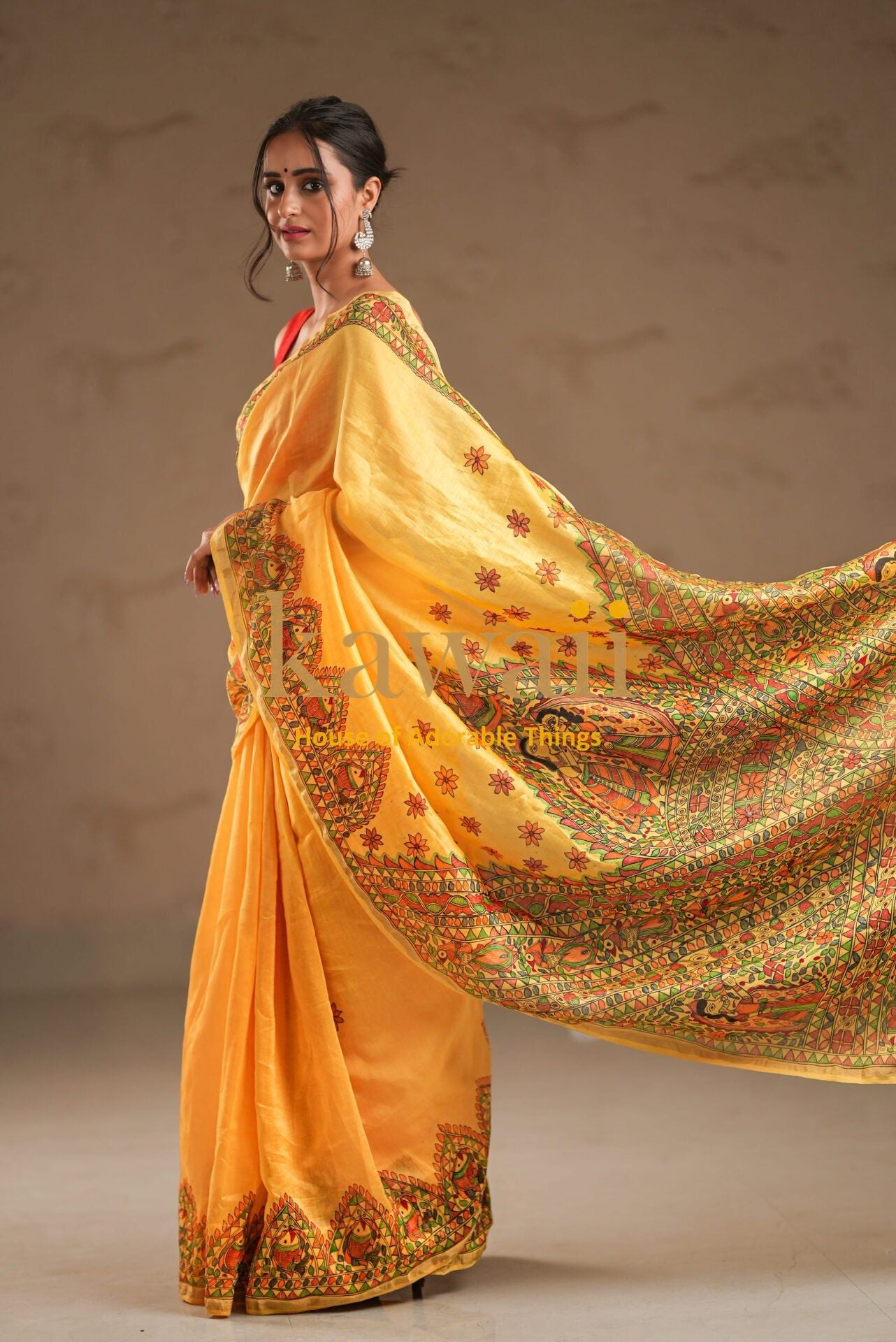 Kawaii yellow madhubani saree with intricate traditional patterns worn by woman