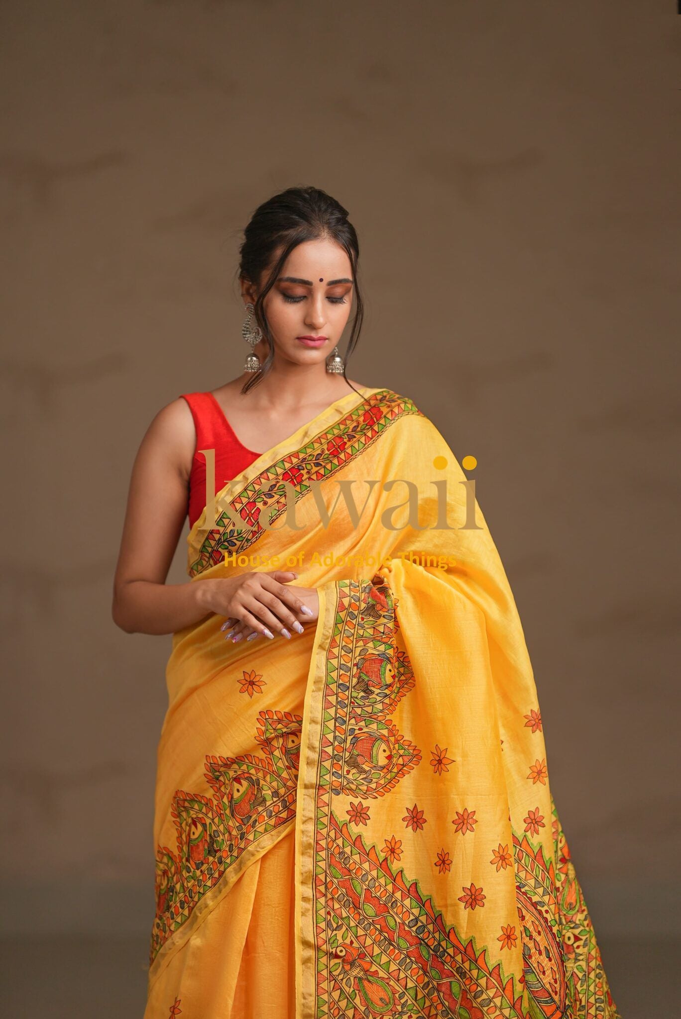 Kawaii yellow madhubani saree with intricate traditional floral and geometric patterns worn by model