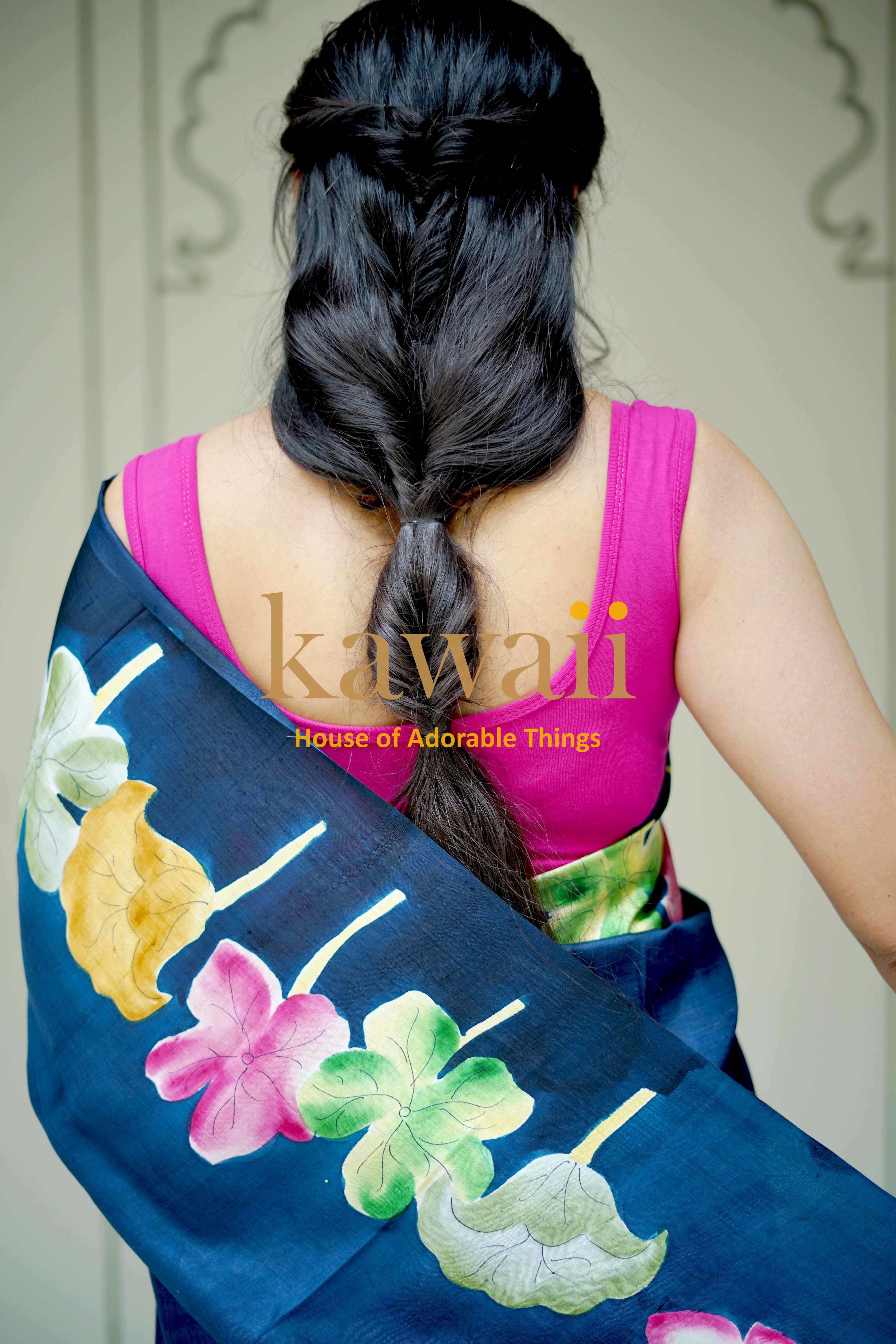 Kawaii pichwai saree with vibrant floral designs draped on woman wearing pink blouse