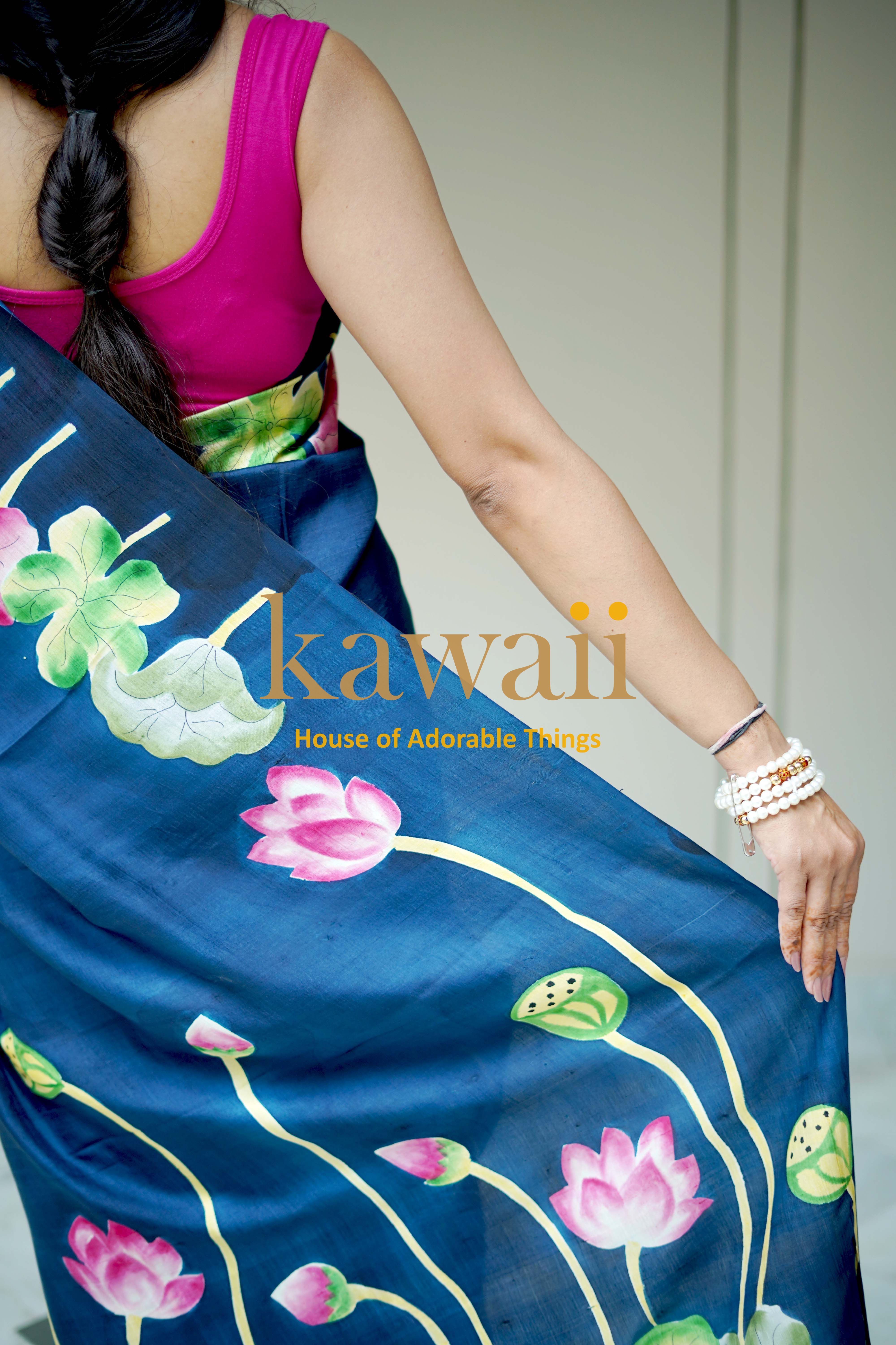 Kawaii pichwai saree in blue with hand-painted lotus flower design draped on woman