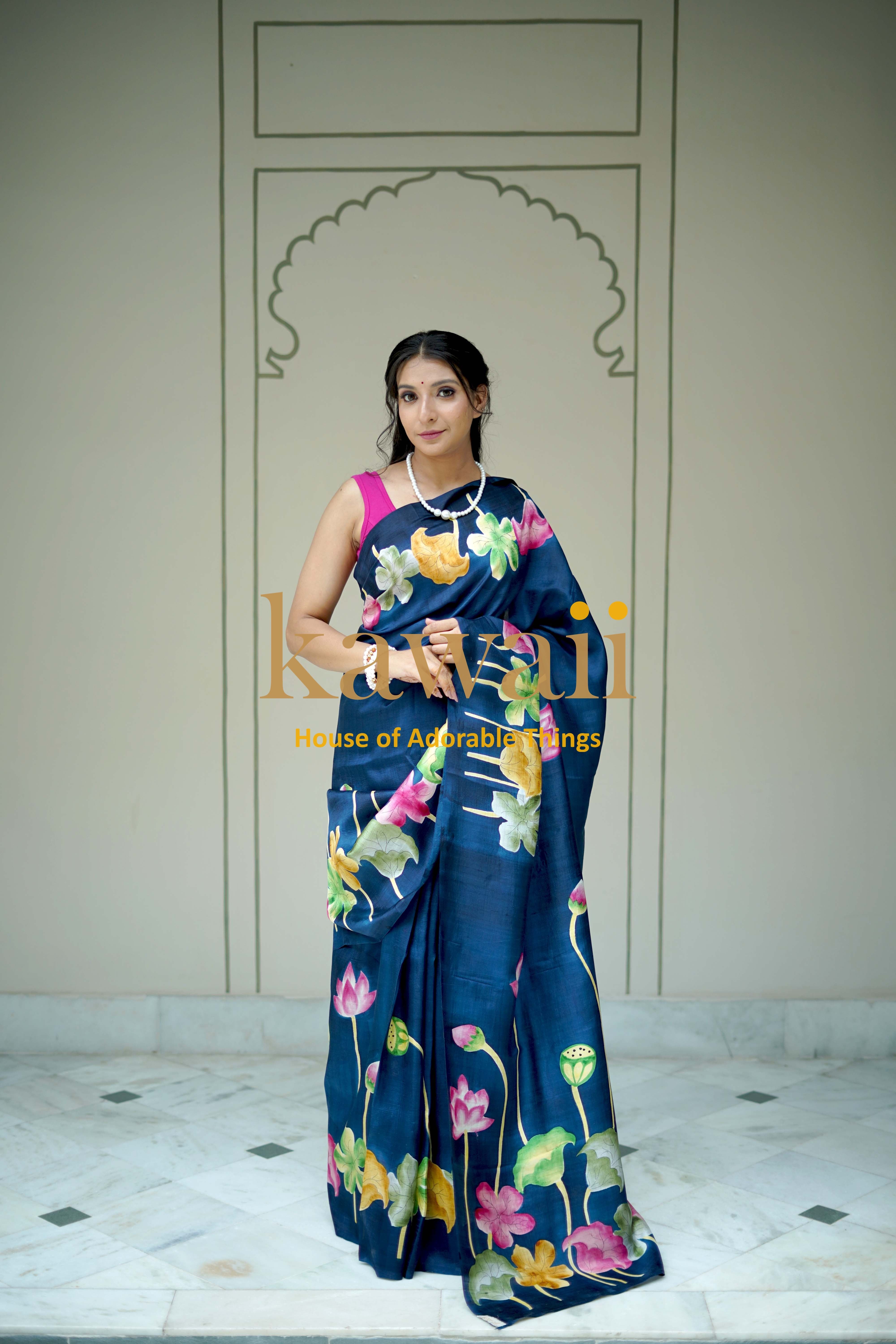 Elegant navy blue pichwai saree with vibrant floral patterns worn by a woman from Kawaii