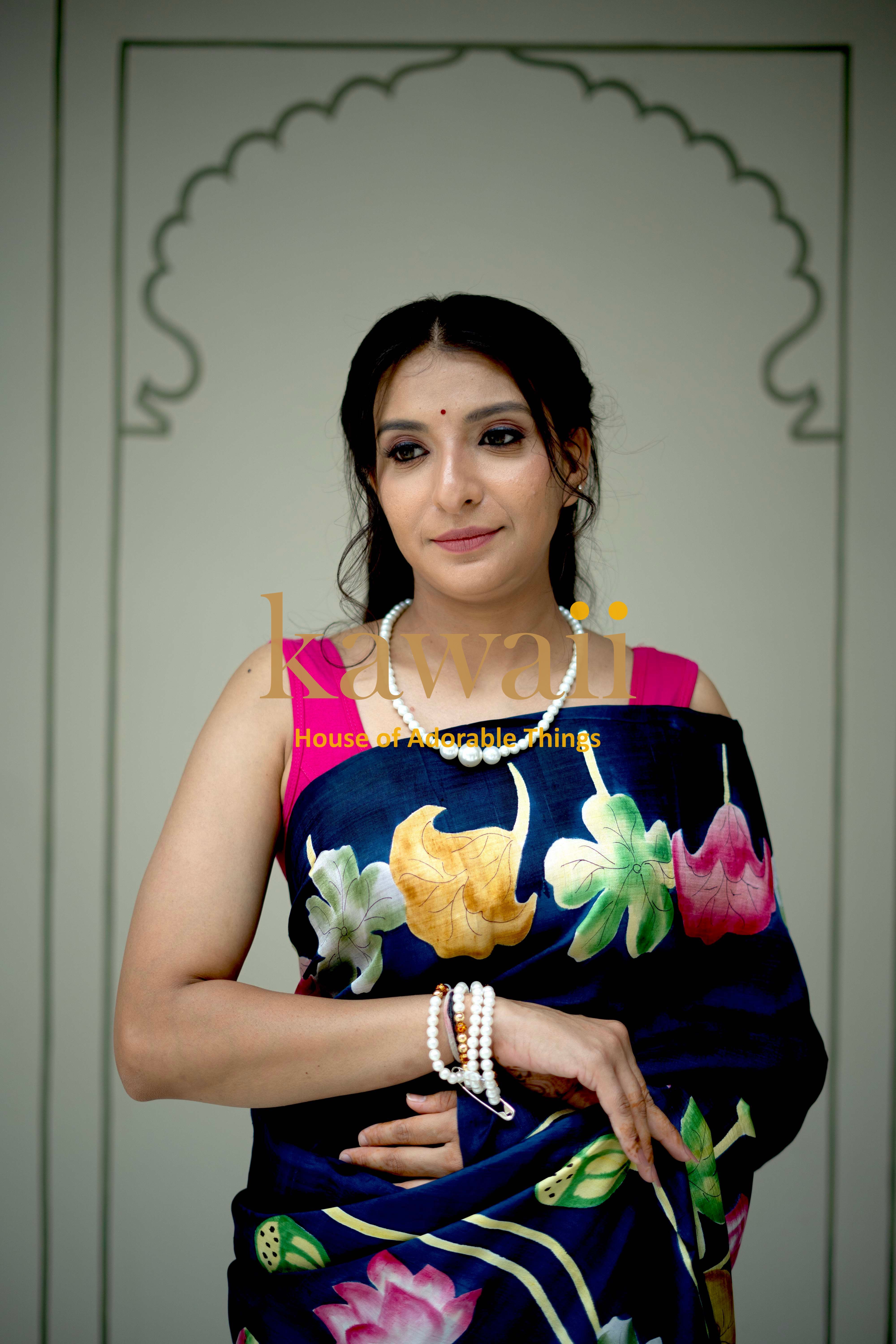 Woman wearing a blue floral pichwai saree by Kawaii with traditional intricate designs