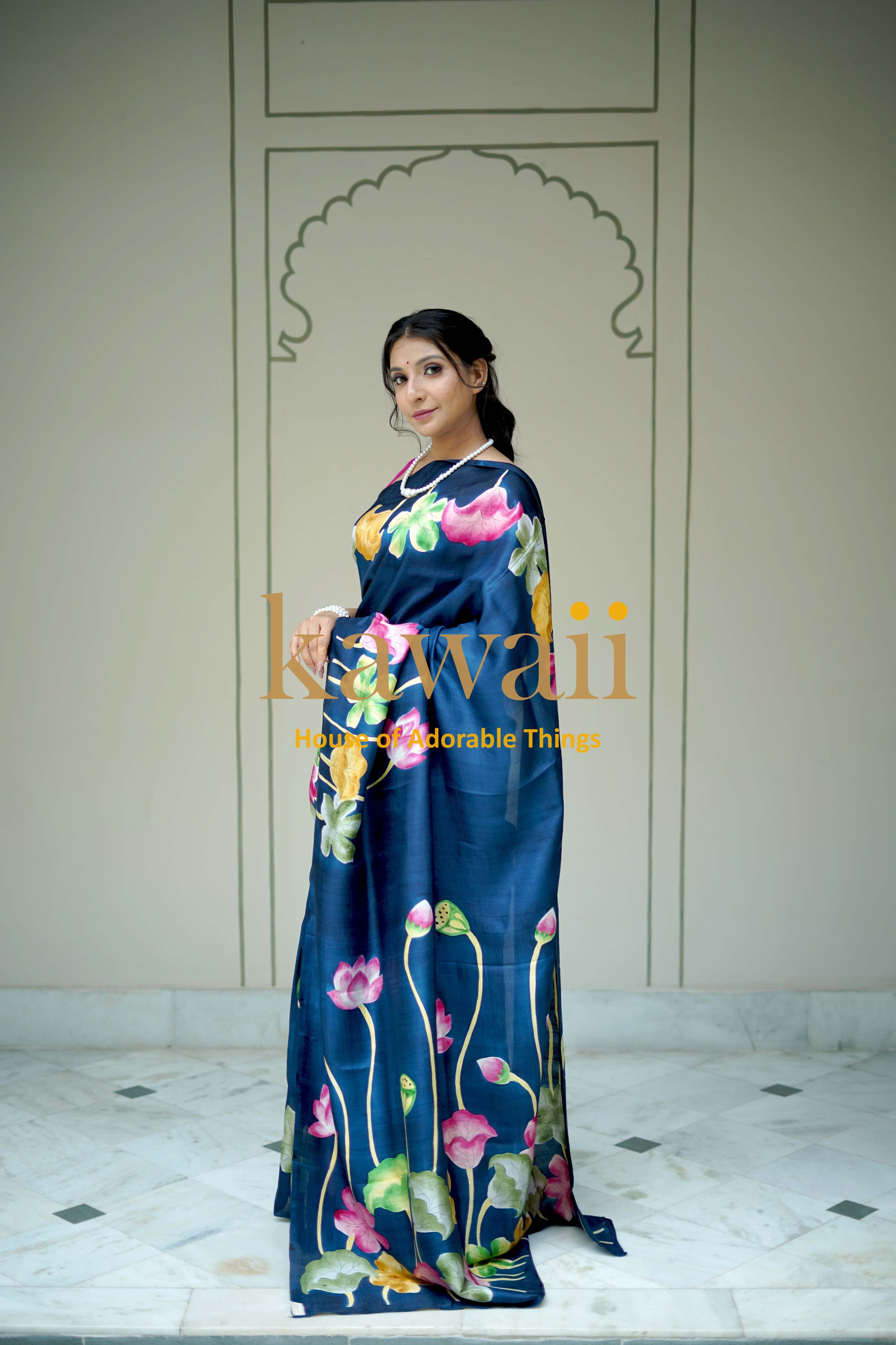Kawaii pichwai saree featuring a navy blue fabric with vibrant floral lotus designs