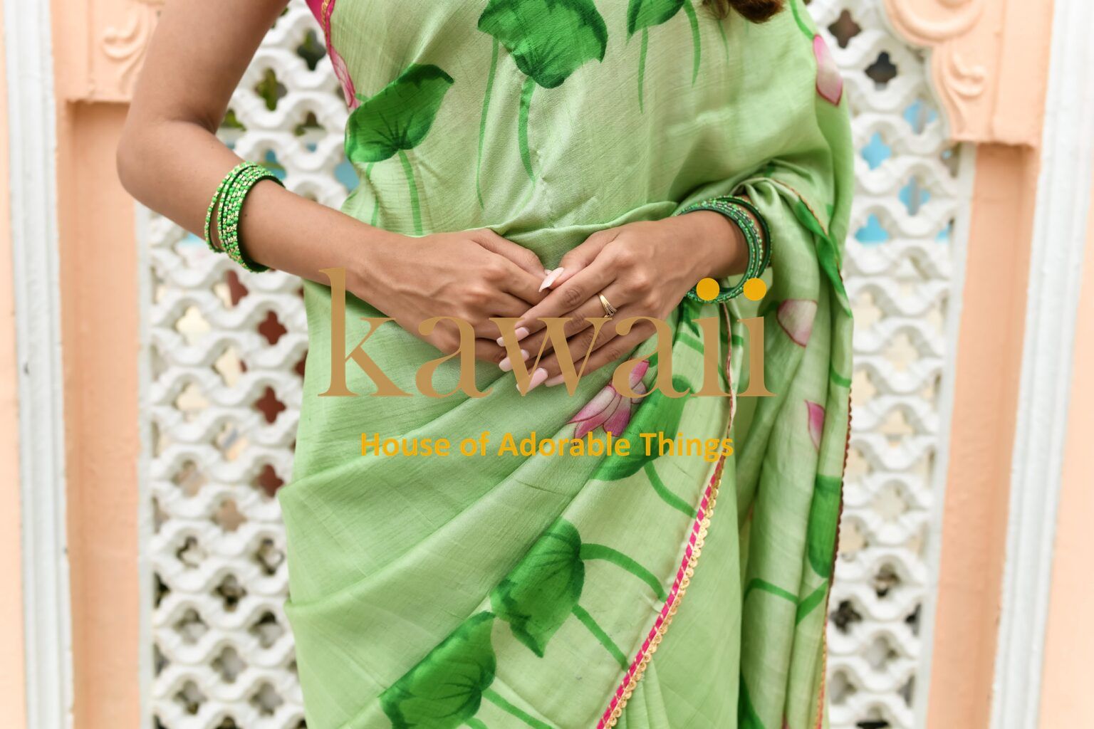 Kawaii green pichwai saree with floral design and matching bangles worn by a woman