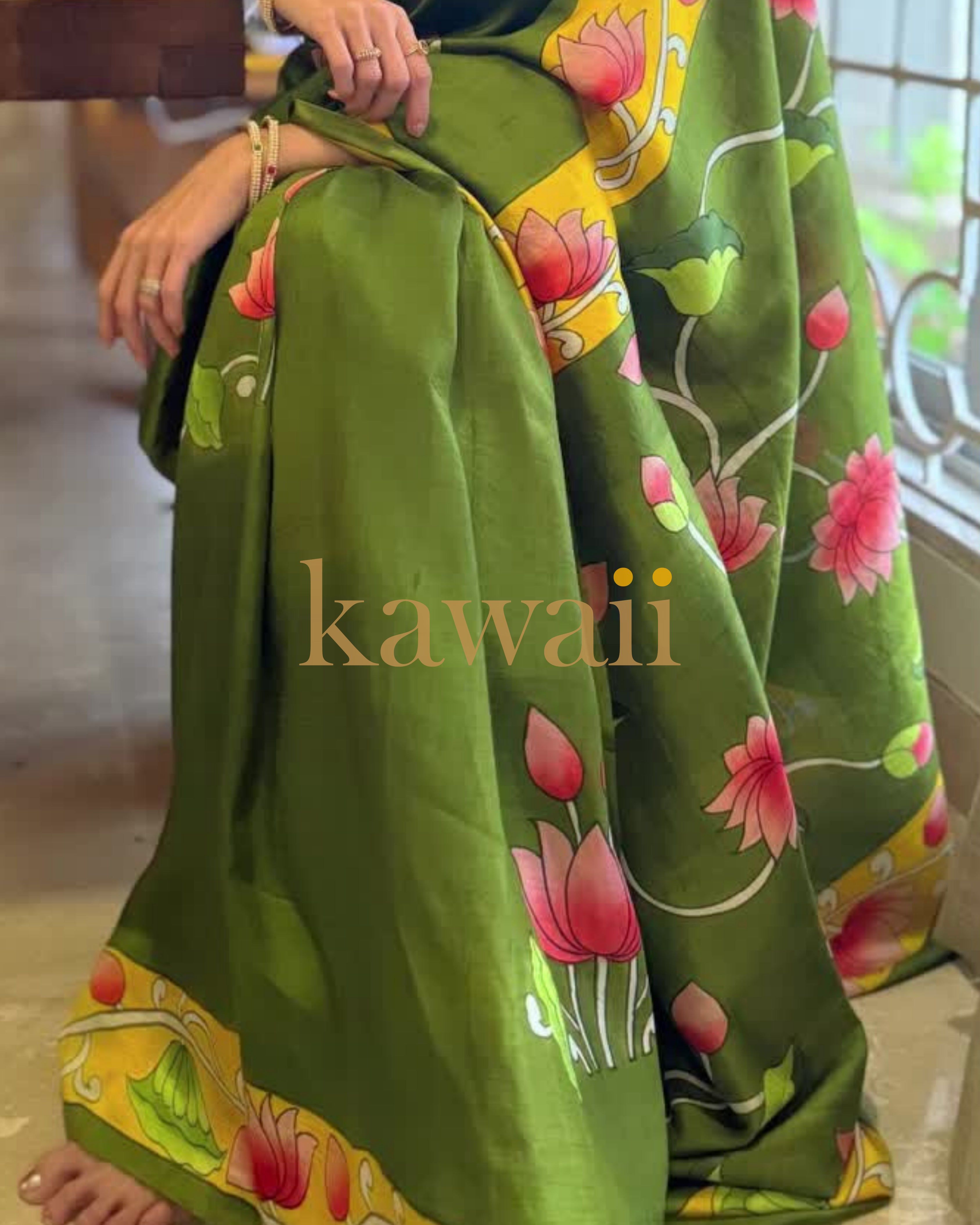 Pichwai saree in green with vibrant floral patterns and intricate designs, crafted from soft fabric