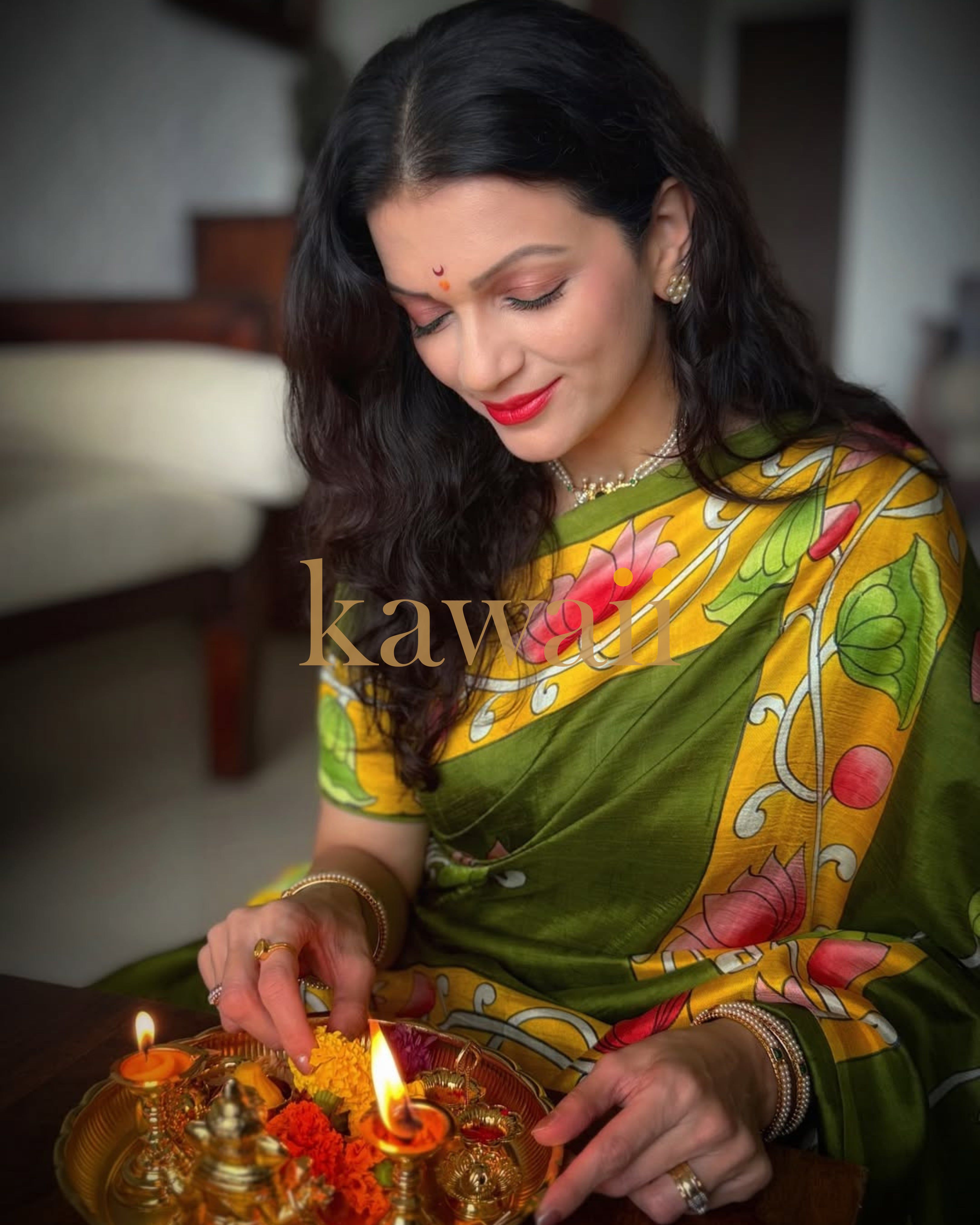 Elegant green pichwai saree with vibrant floral patterns, perfect for festive occasions