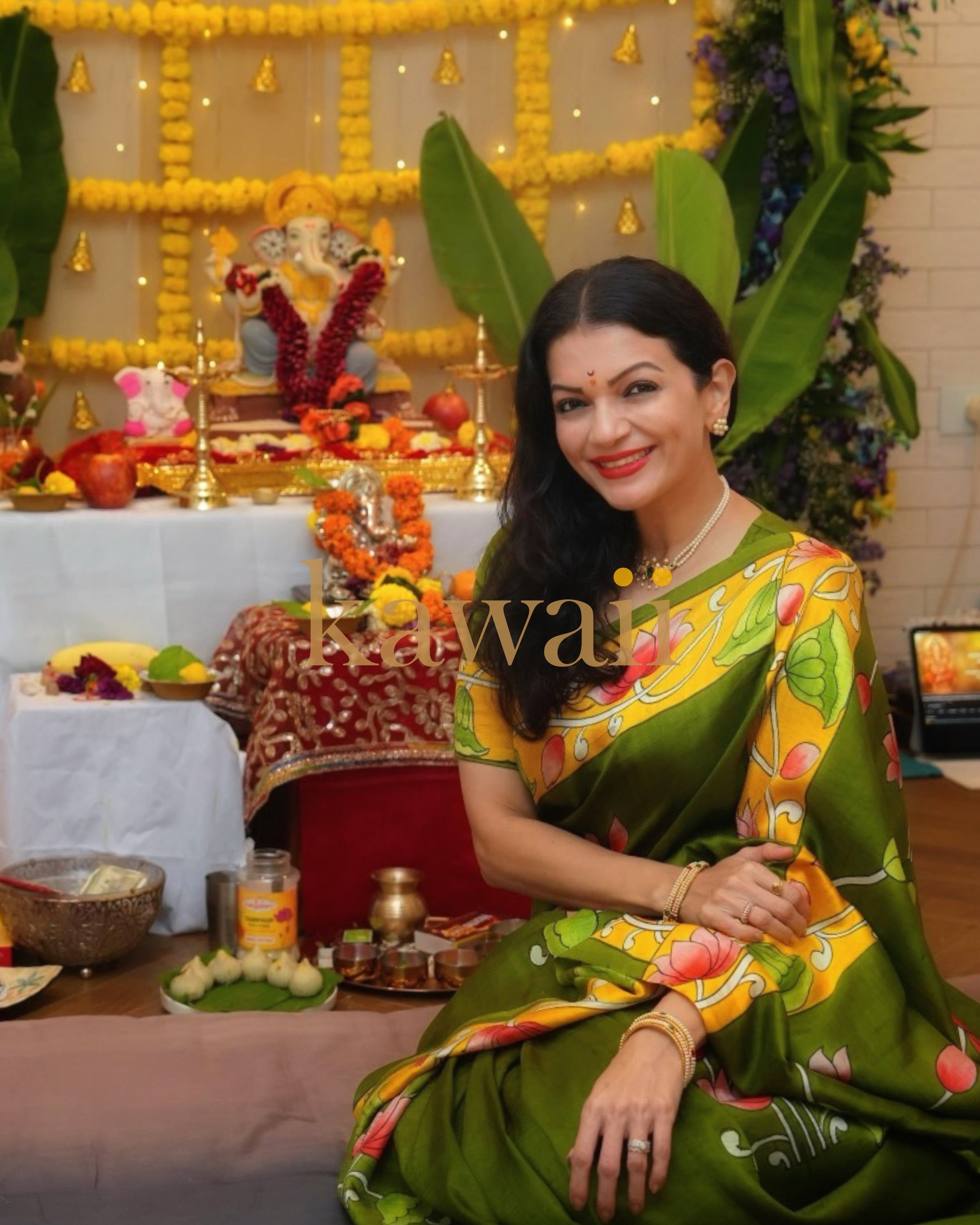 Elegant green pichwai saree with vibrant floral designs, perfect for festive celebrations