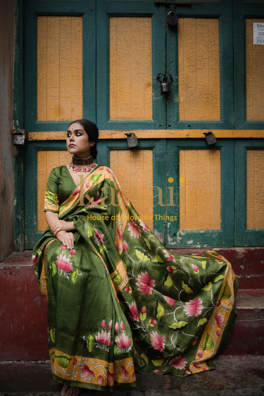 Woman wearing green floral pichwai saree by Kawaii with intricate traditional design