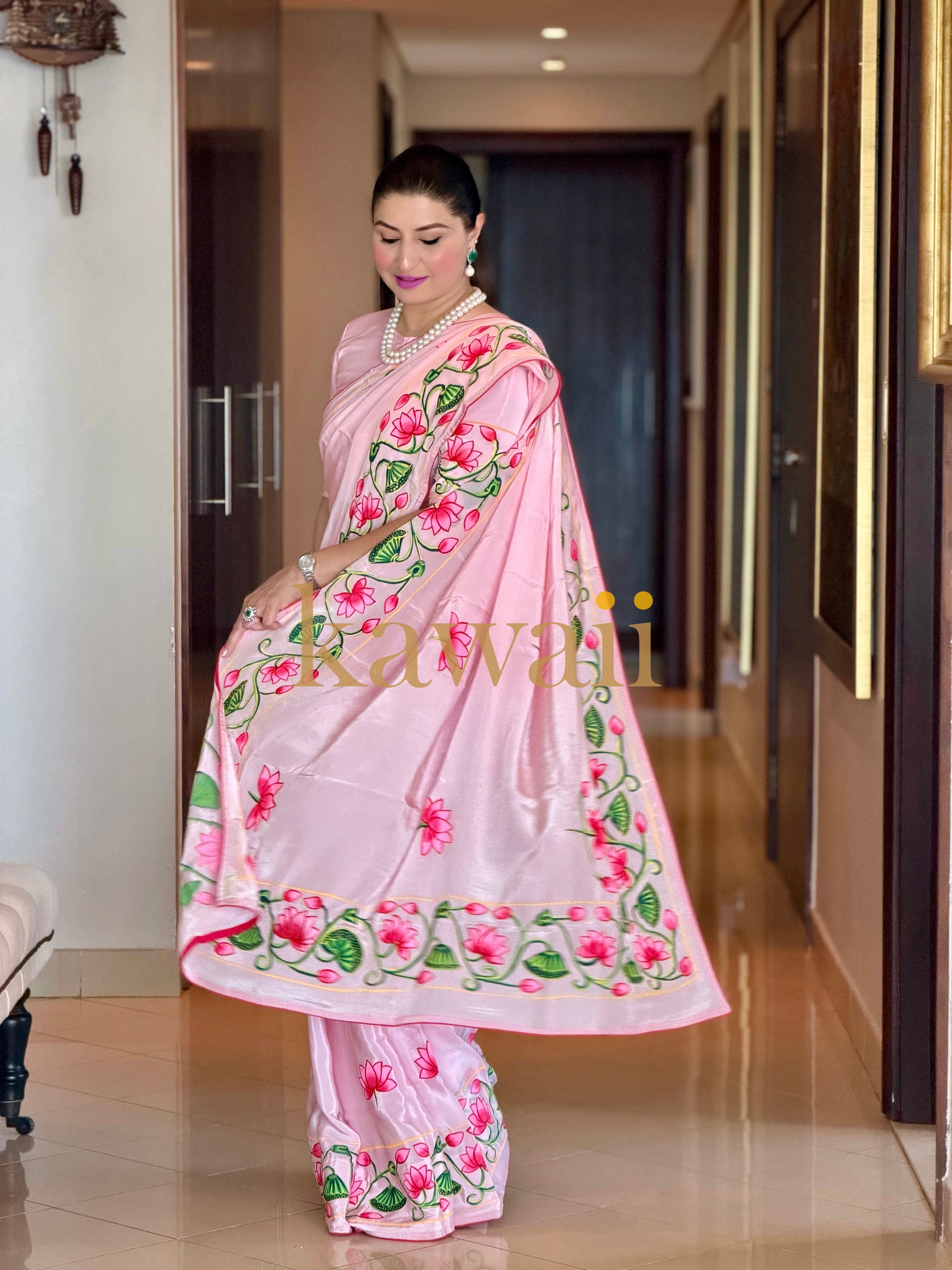 Elegant woman in a pink pichwai saree with floral designs, showcasing traditional elegance