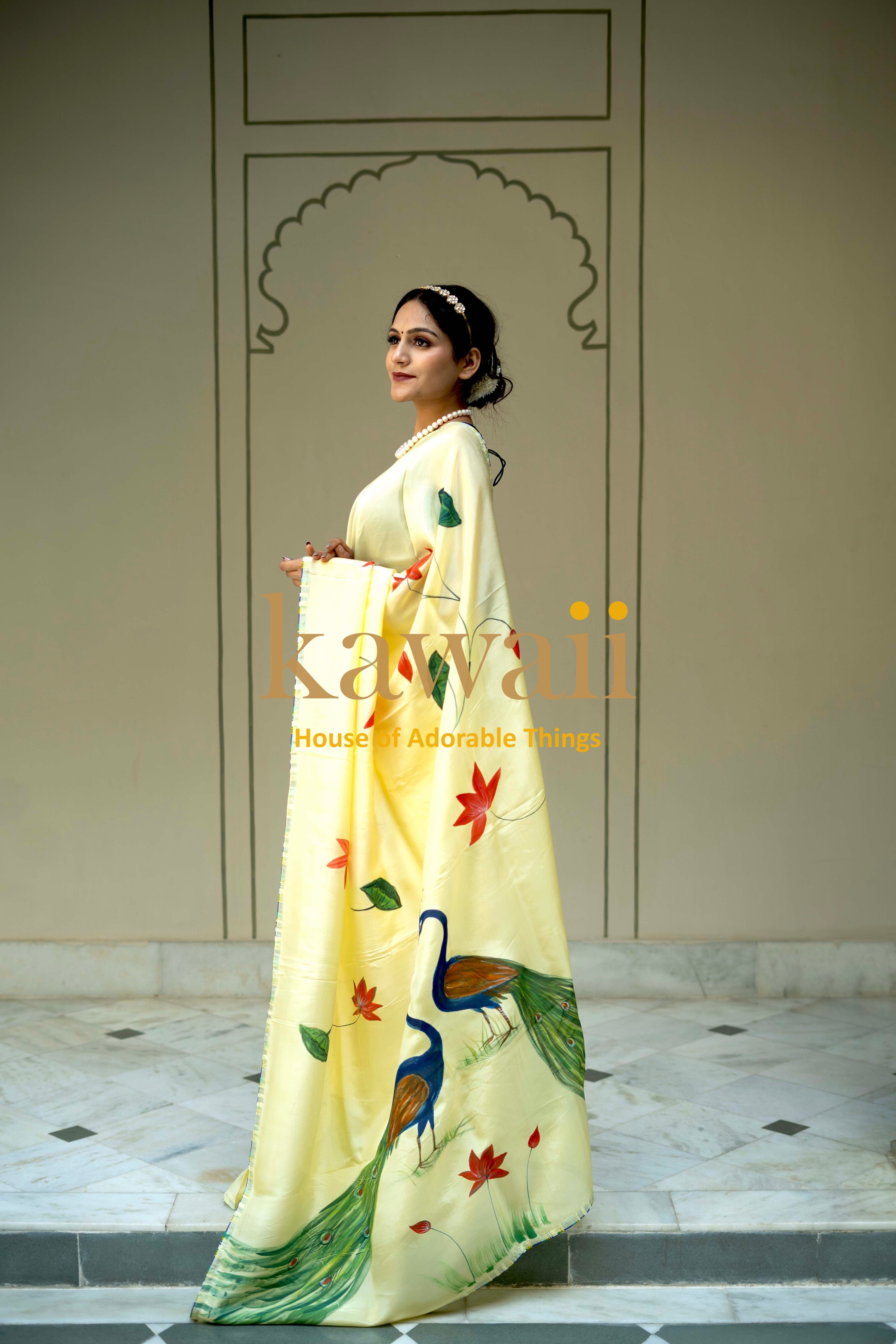 Kawaii yellow pichwai saree featuring traditional peacock and floral designs worn by a woman