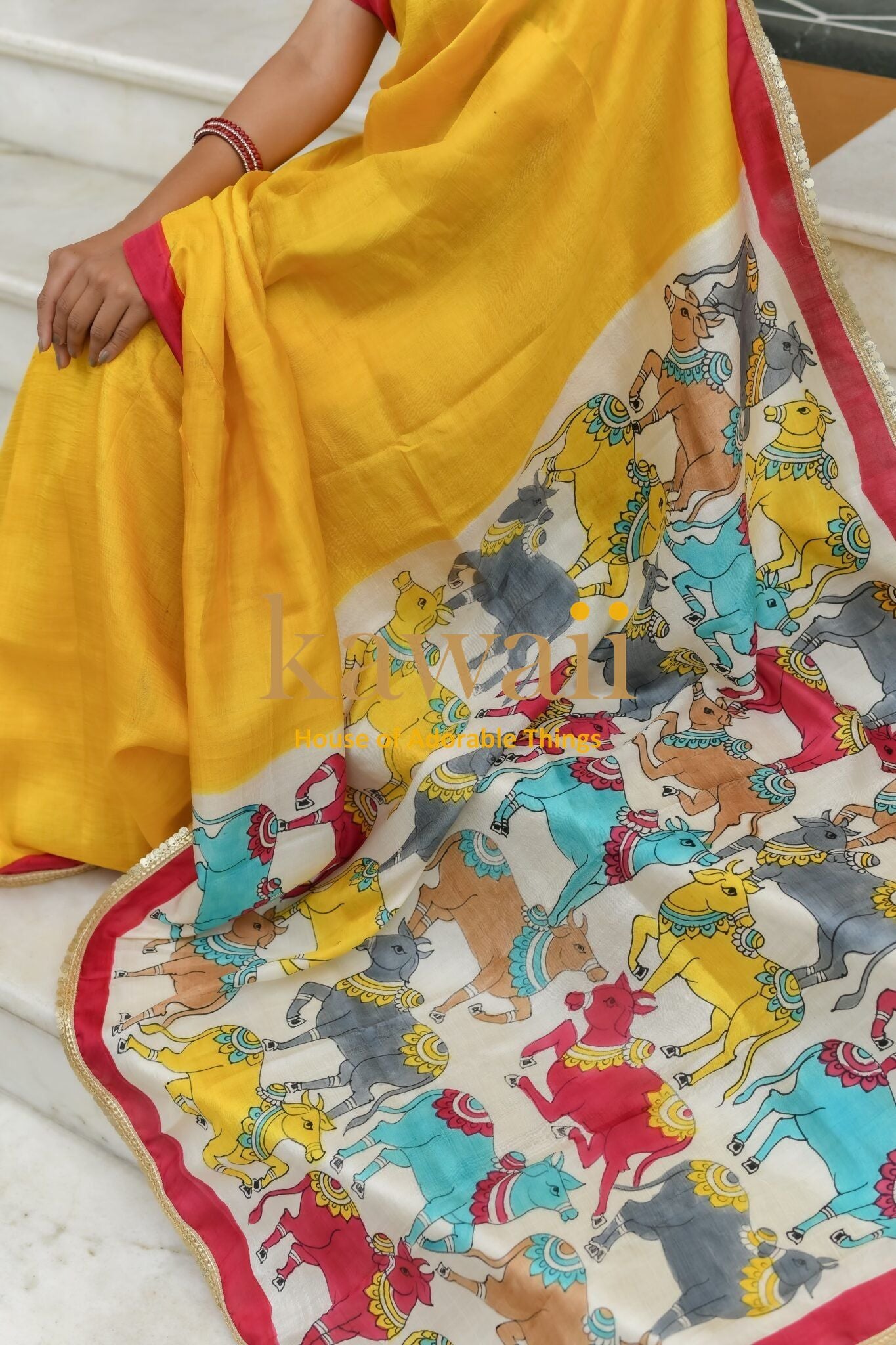 Kawaii yellow pichwai saree featuring colorful traditional horse motifs and a red border