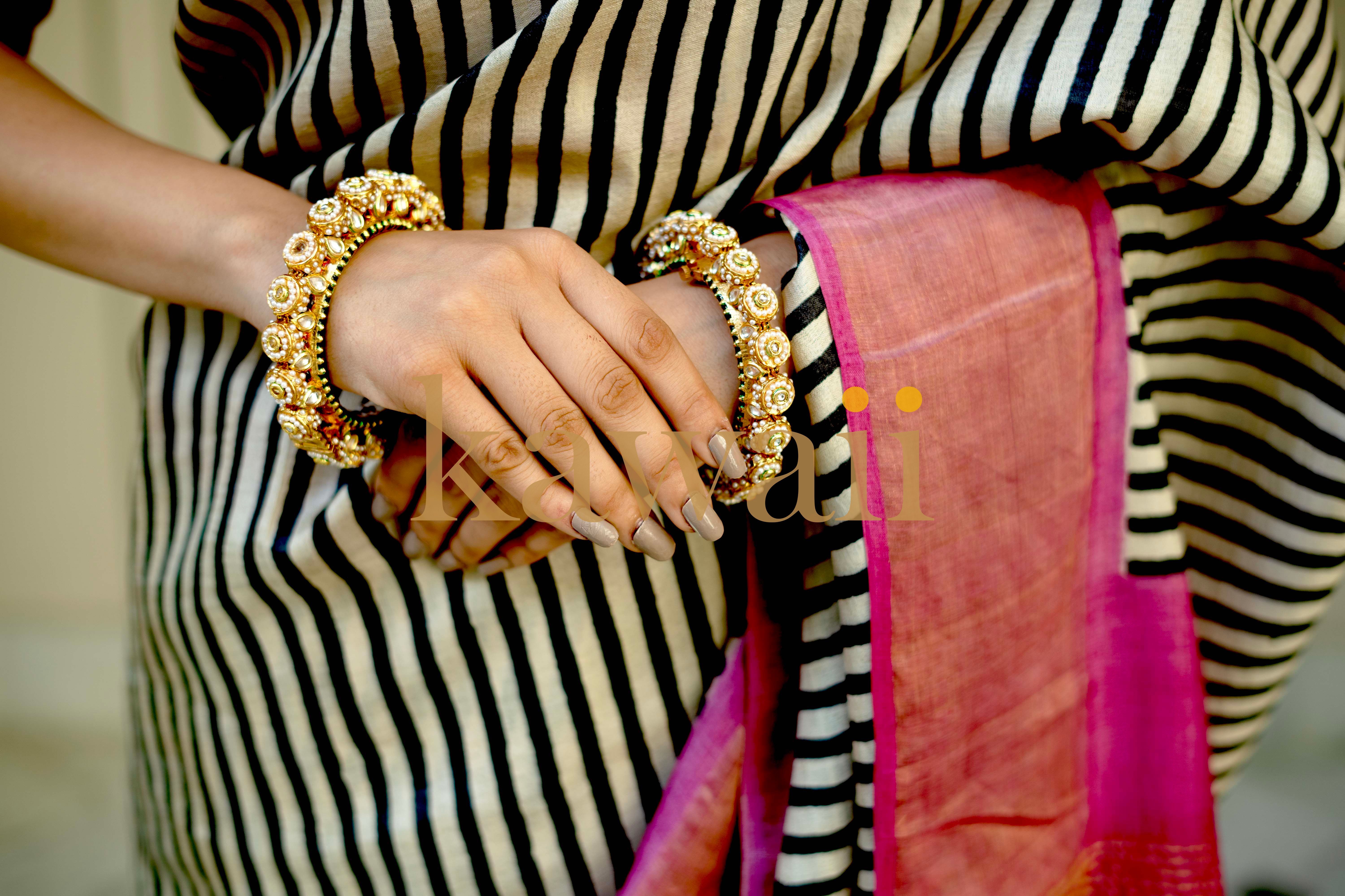 Stylish block print saree in tussar silk saree design with elegant bangles and a pink drape