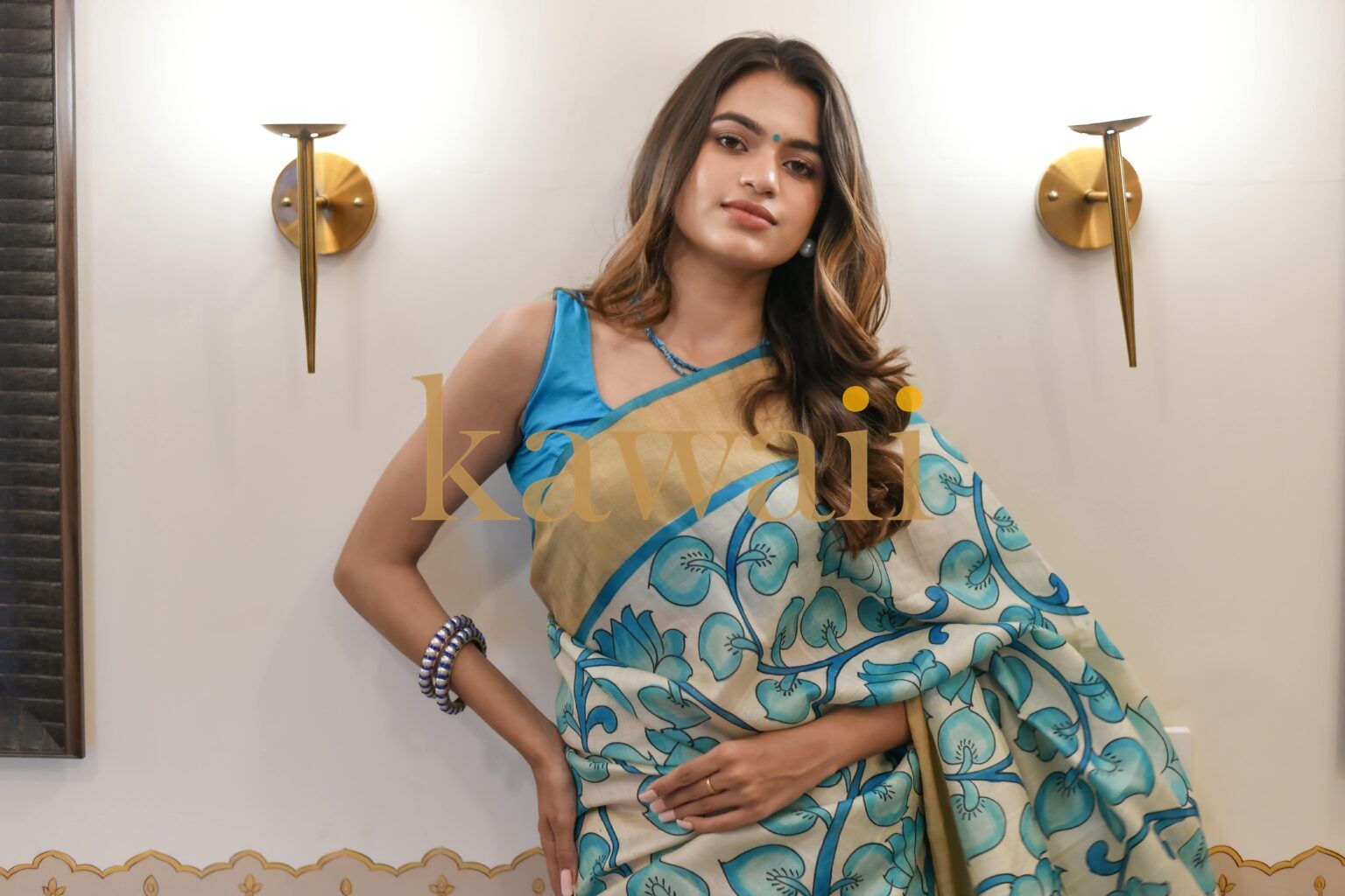 Elegant kalamkari saree with intricate blue floral patterns and a beige border, crafted in lightweight fabric