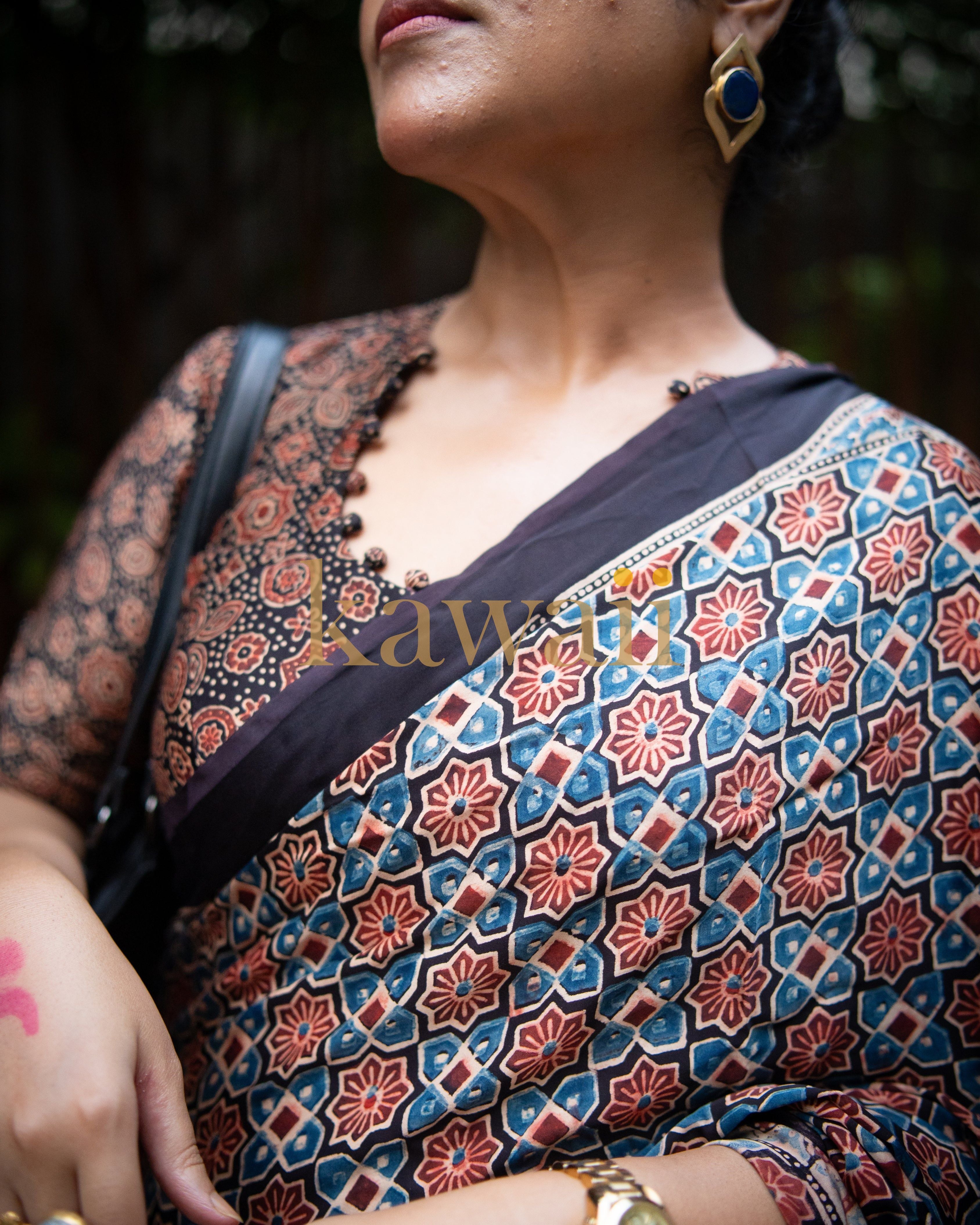 Woman wearing the best authentic ajrakh saree by Kawaii with intricate blue and red floral patterns