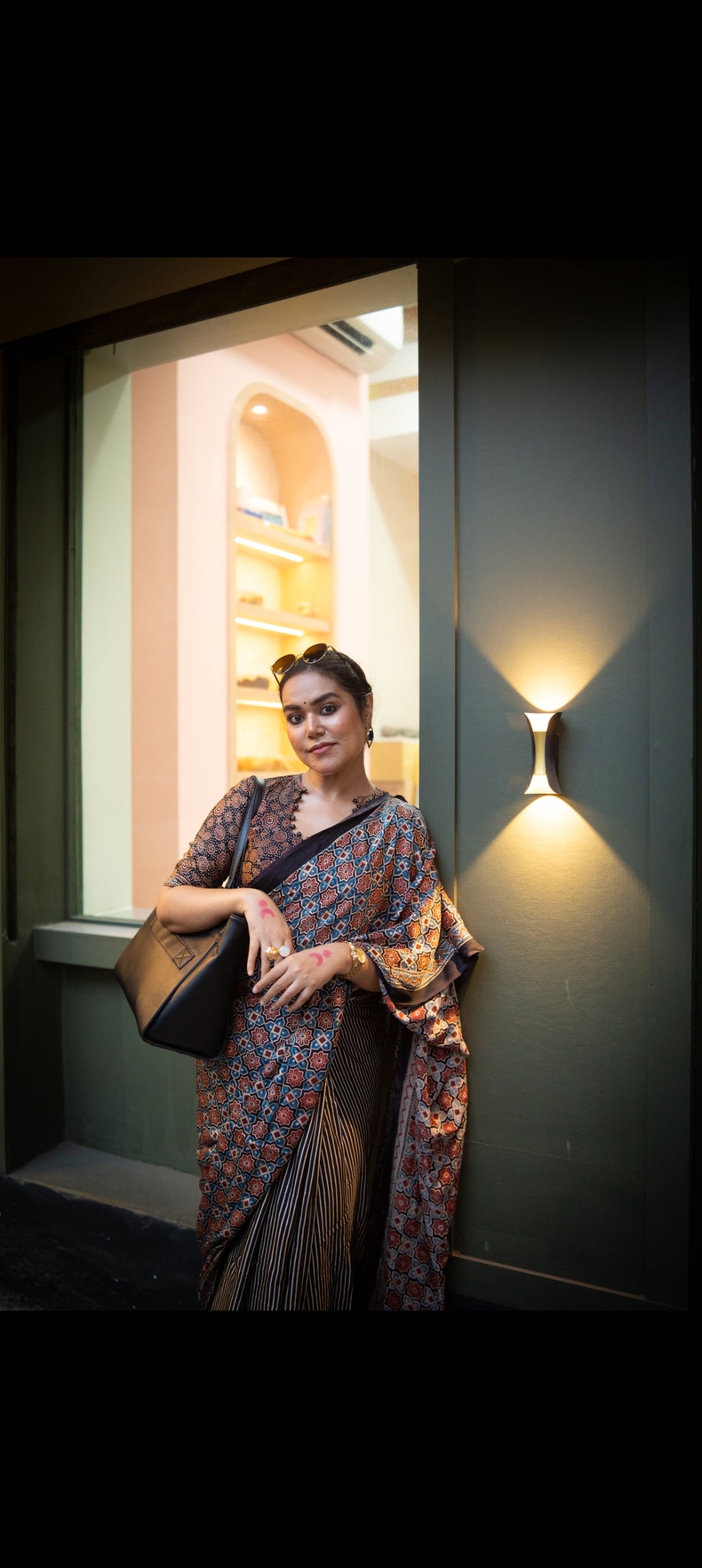 Woman wearing the best authentic ajrakh saree by Kawaii with traditional geometric patterns and earthy tones