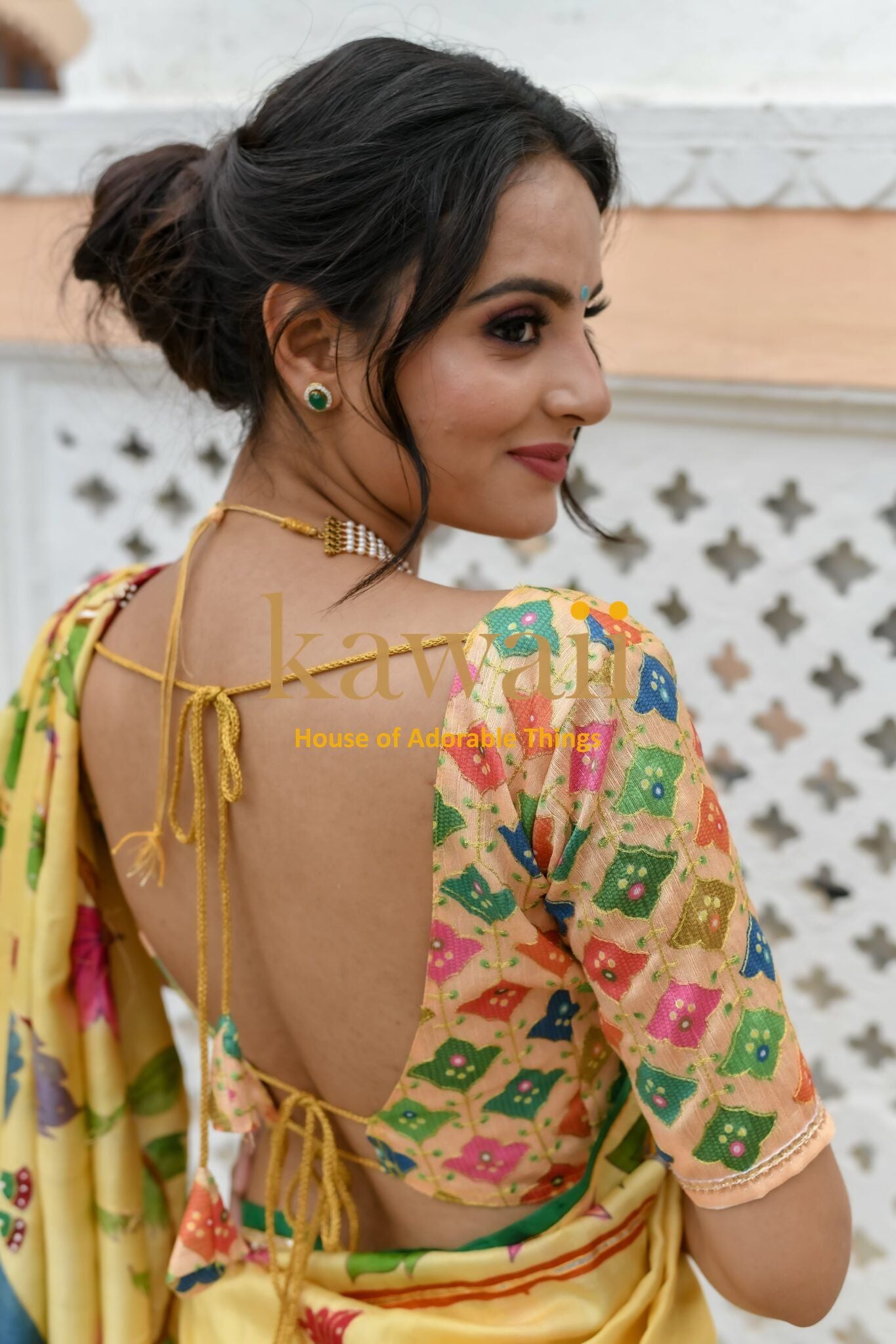 Woman wearing colorful pichwai saree with floral blouse and back tie-up design by Kawaii