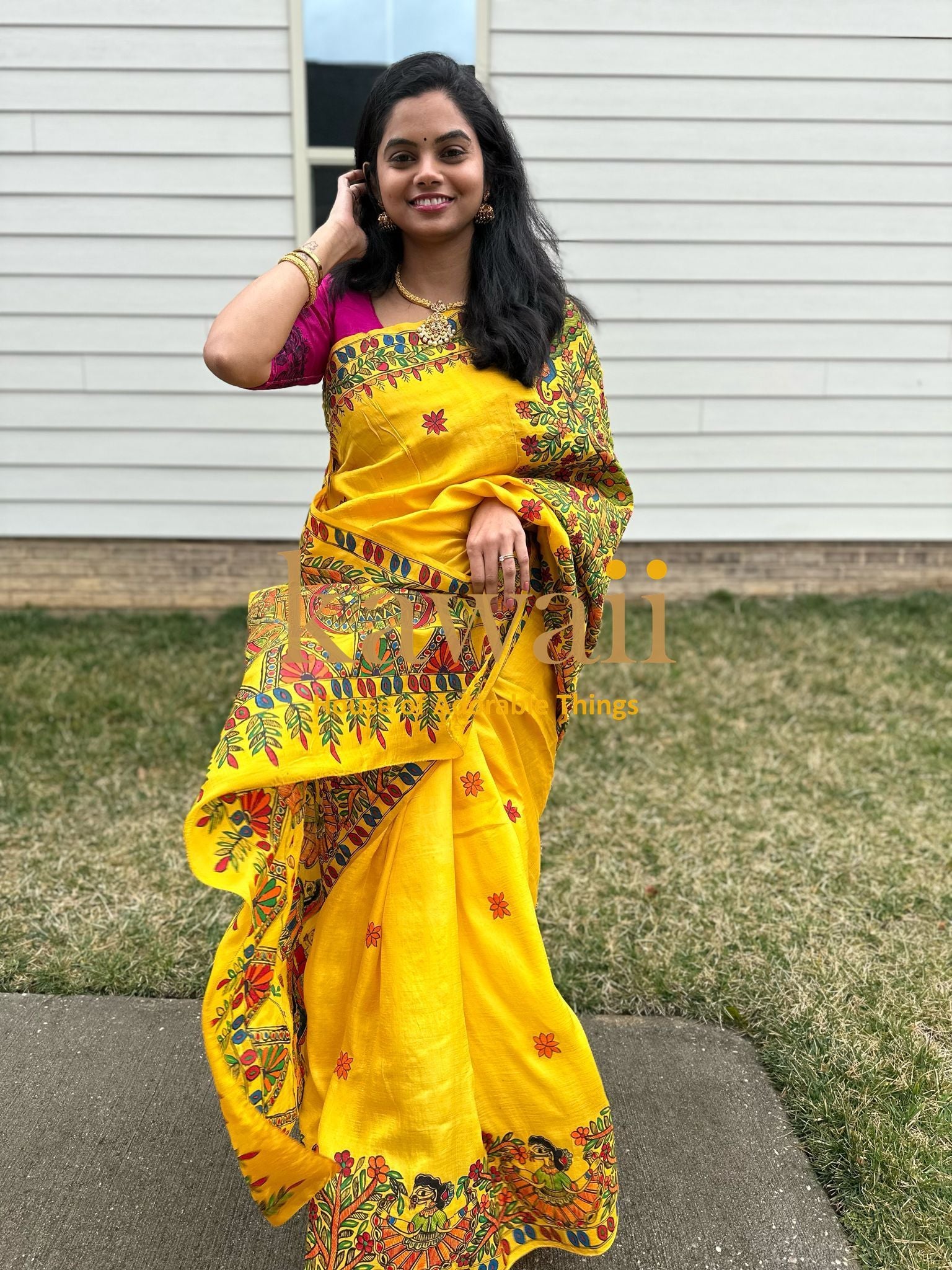 Woman wearing a vibrant yellow madhubani saree with floral and traditional designs by Kawaii