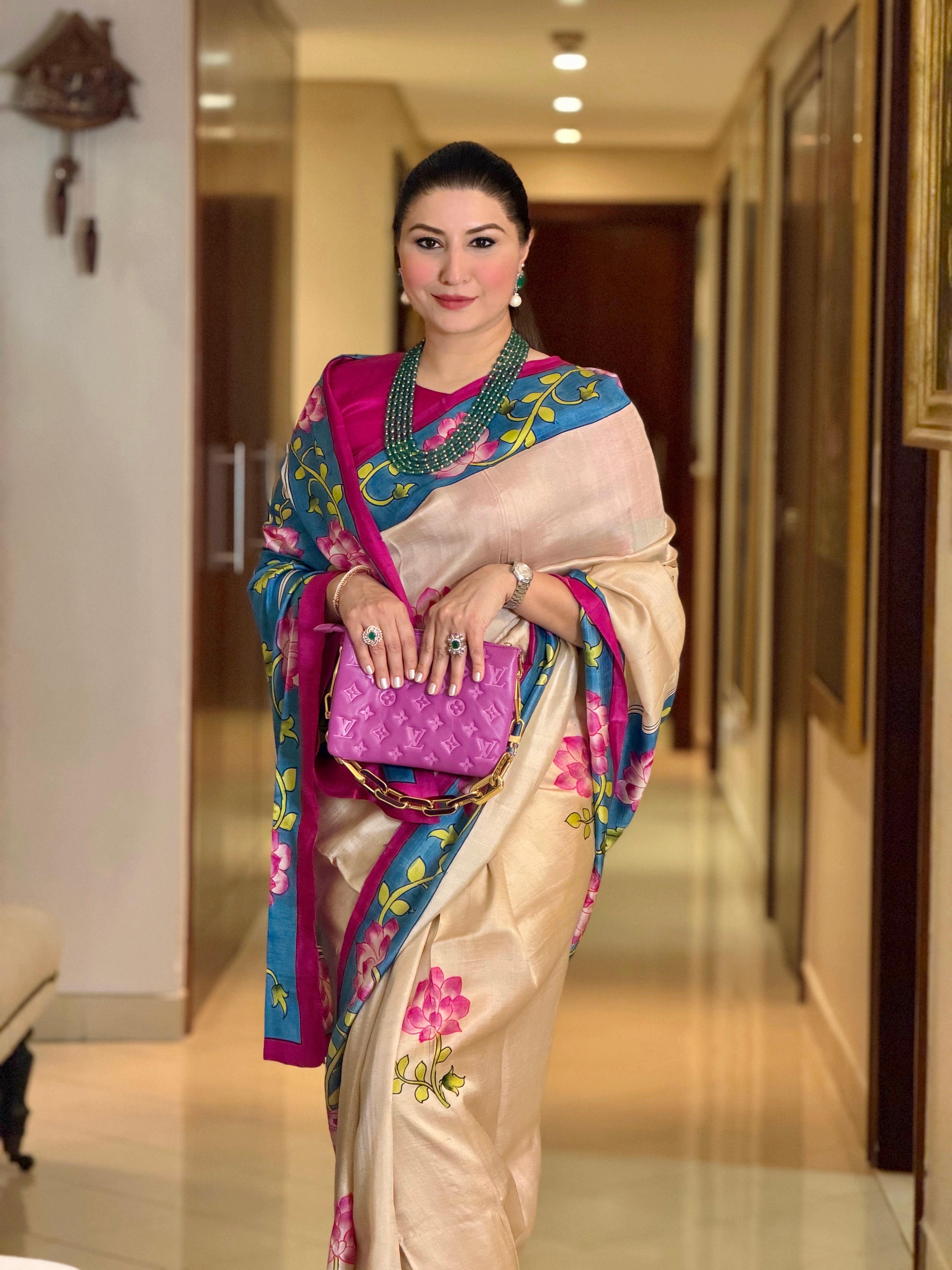 Elegant woman wearing a beautiful pichwai saree with vibrant colors and floral embroidery