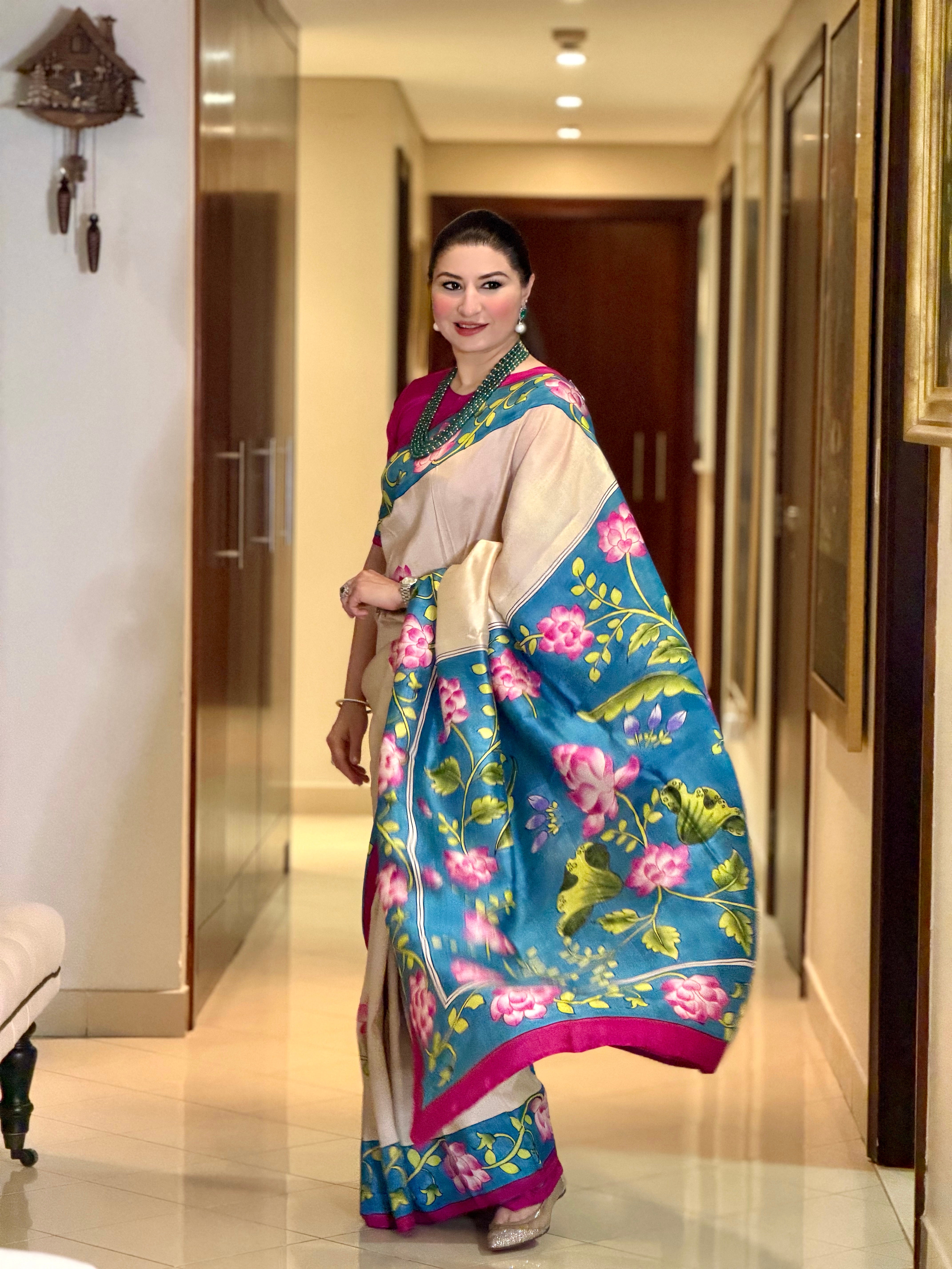 Elegant model wearing a blue and pink pichwai saree with vibrant floral designs and intricate detailing