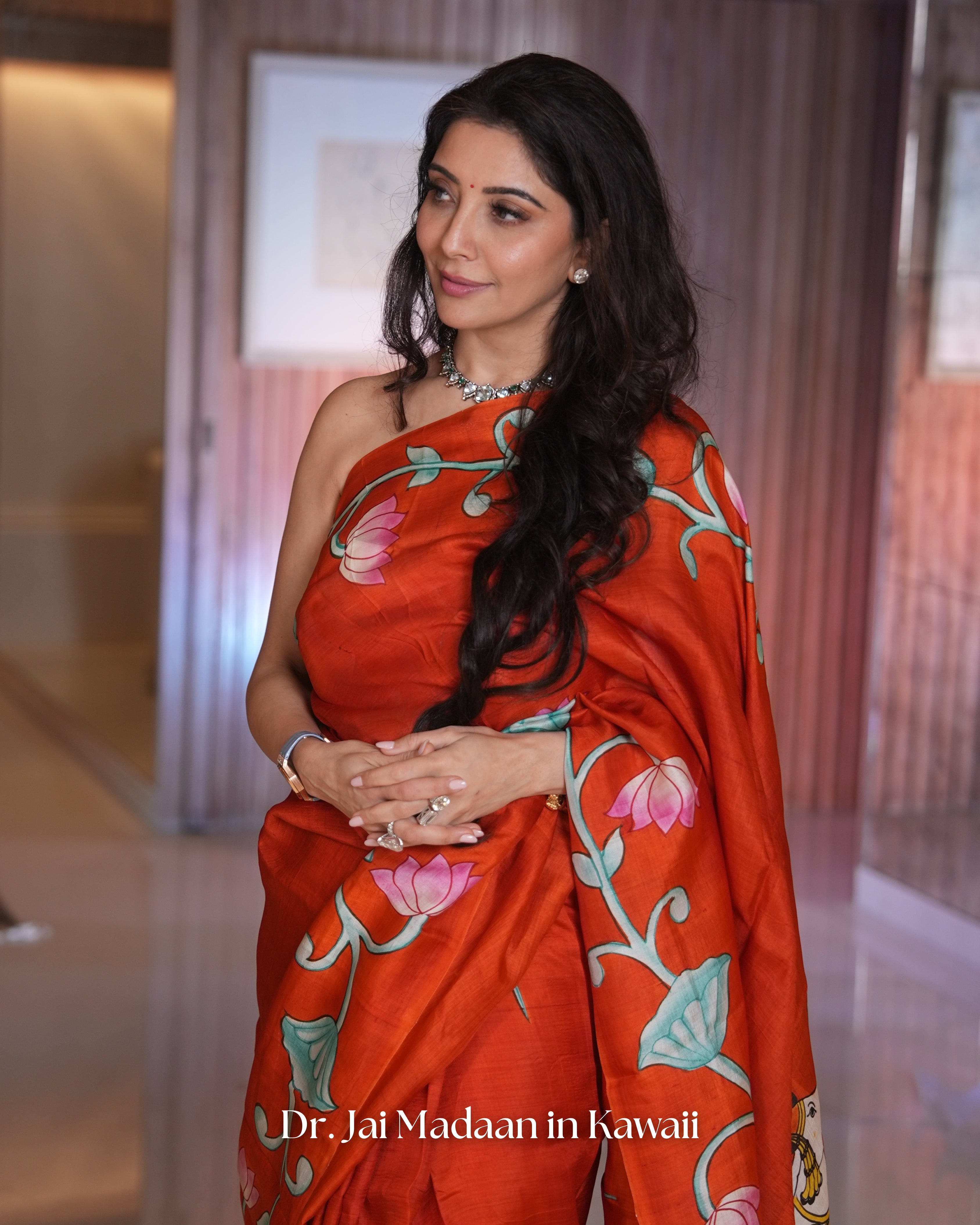 Elegant Pichwai saree by Kawaii featuring vibrant floral designs and rich colors, worn by a model
