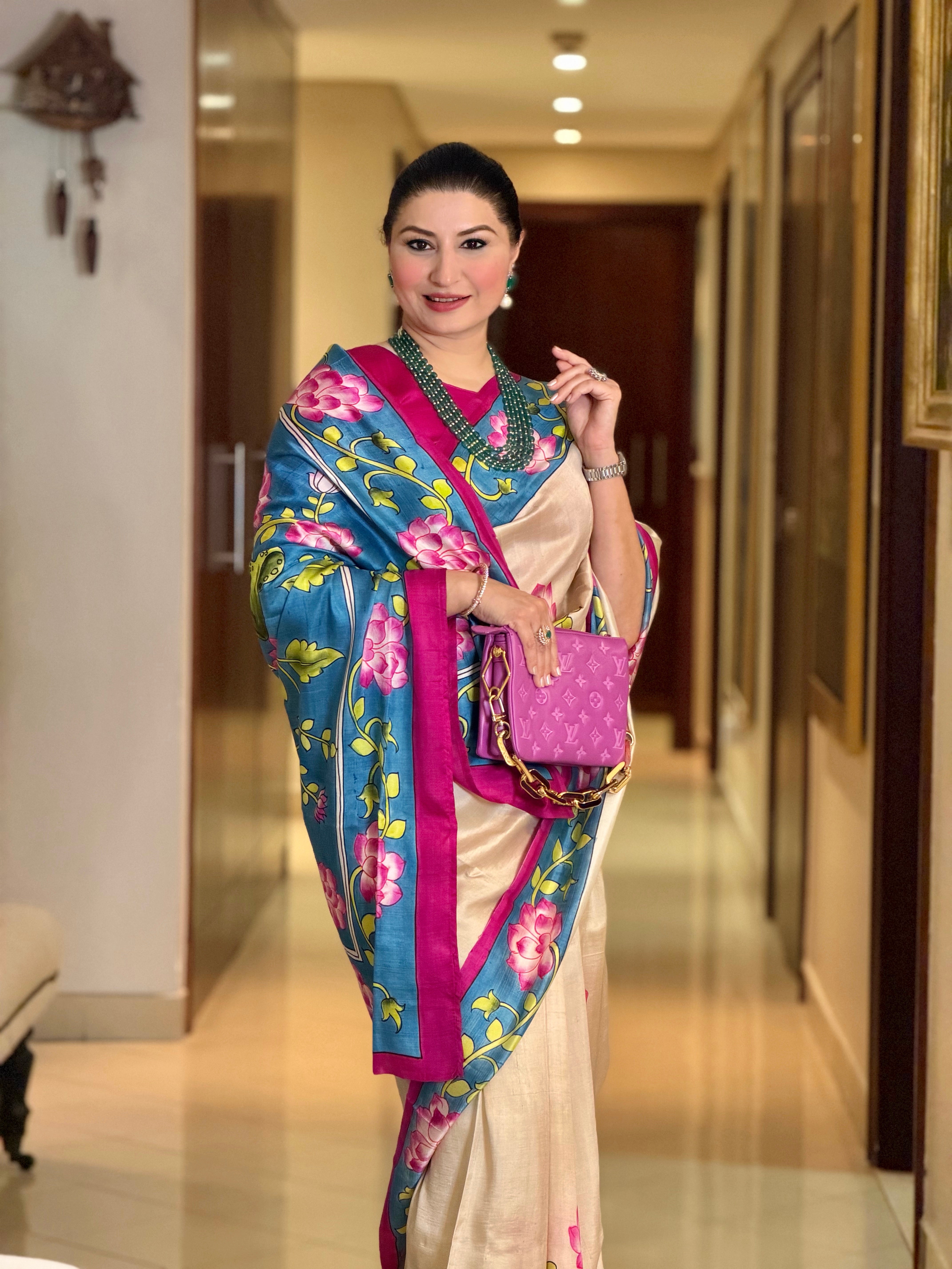 Elegant woman wearing a pichwai saree with floral designs, styled for a formal occasion